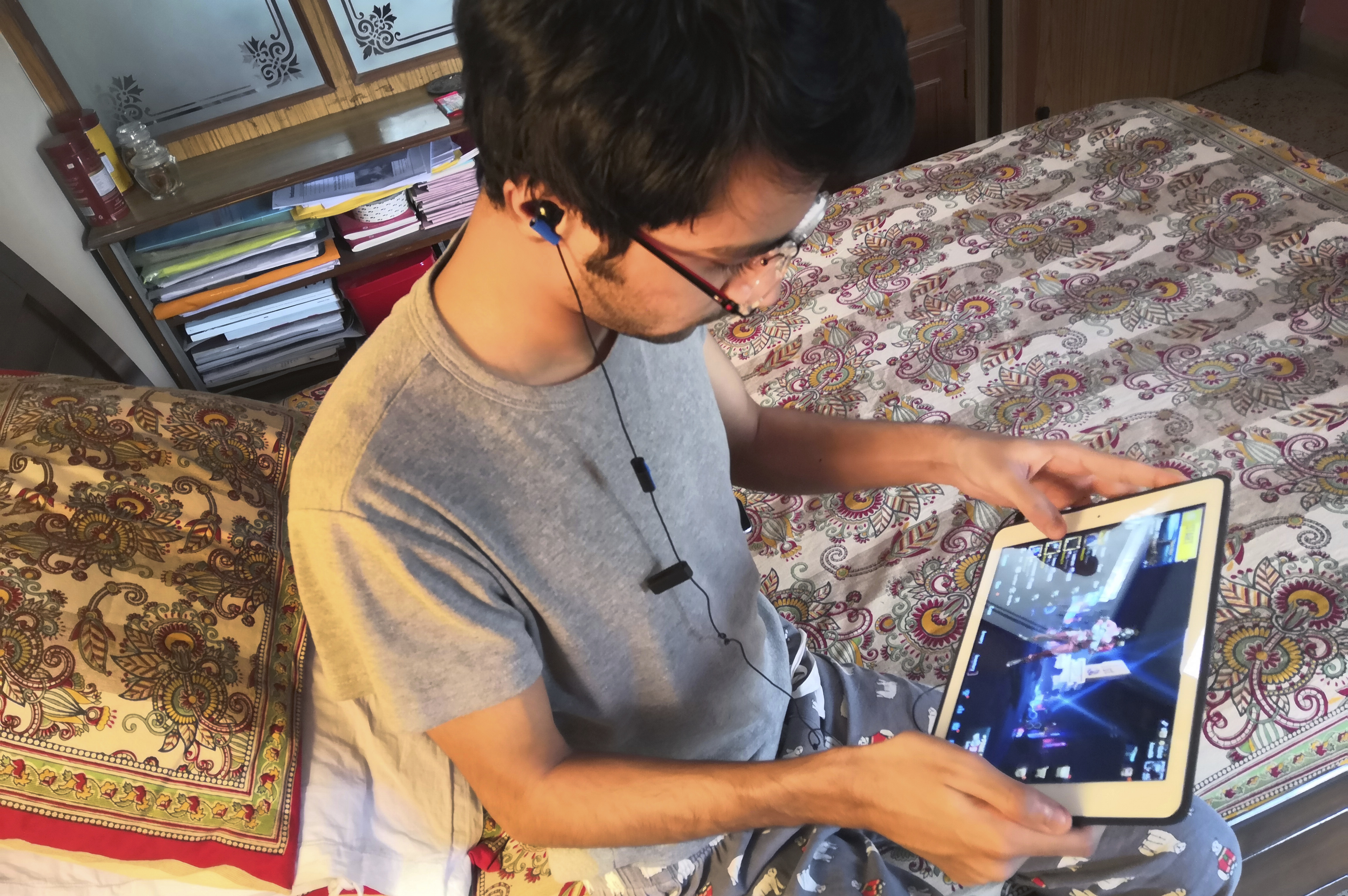 A youth plays an online game PUBG on his notebook in New Delhi, India