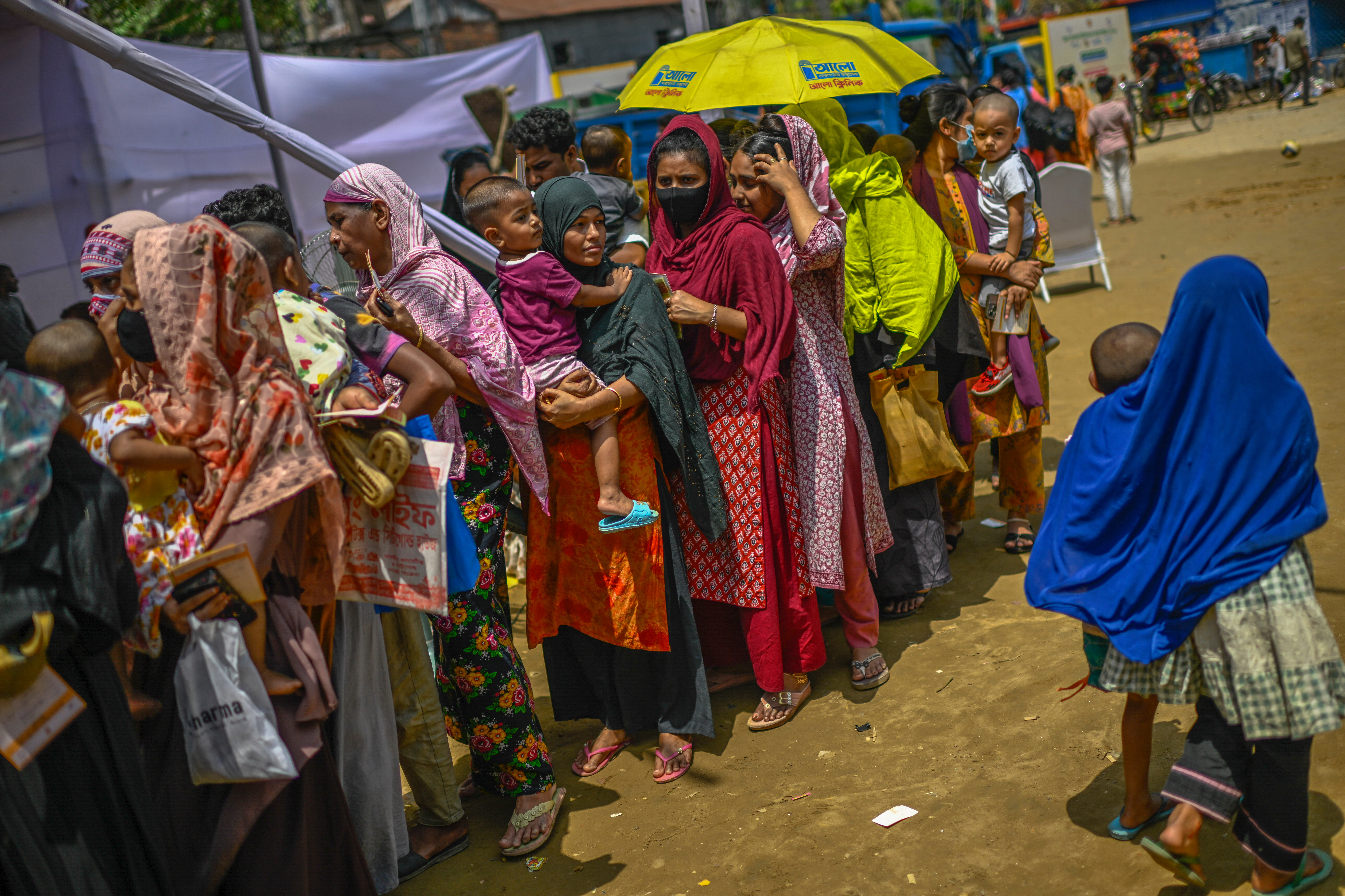 Mothers with their children wait in a queue to receive measles vaccinations amid a rising outbreak in Dhaka, Bangladesh, Sunday, April 12, 2026. (AP Photo/Mahmud Hossain Opu)