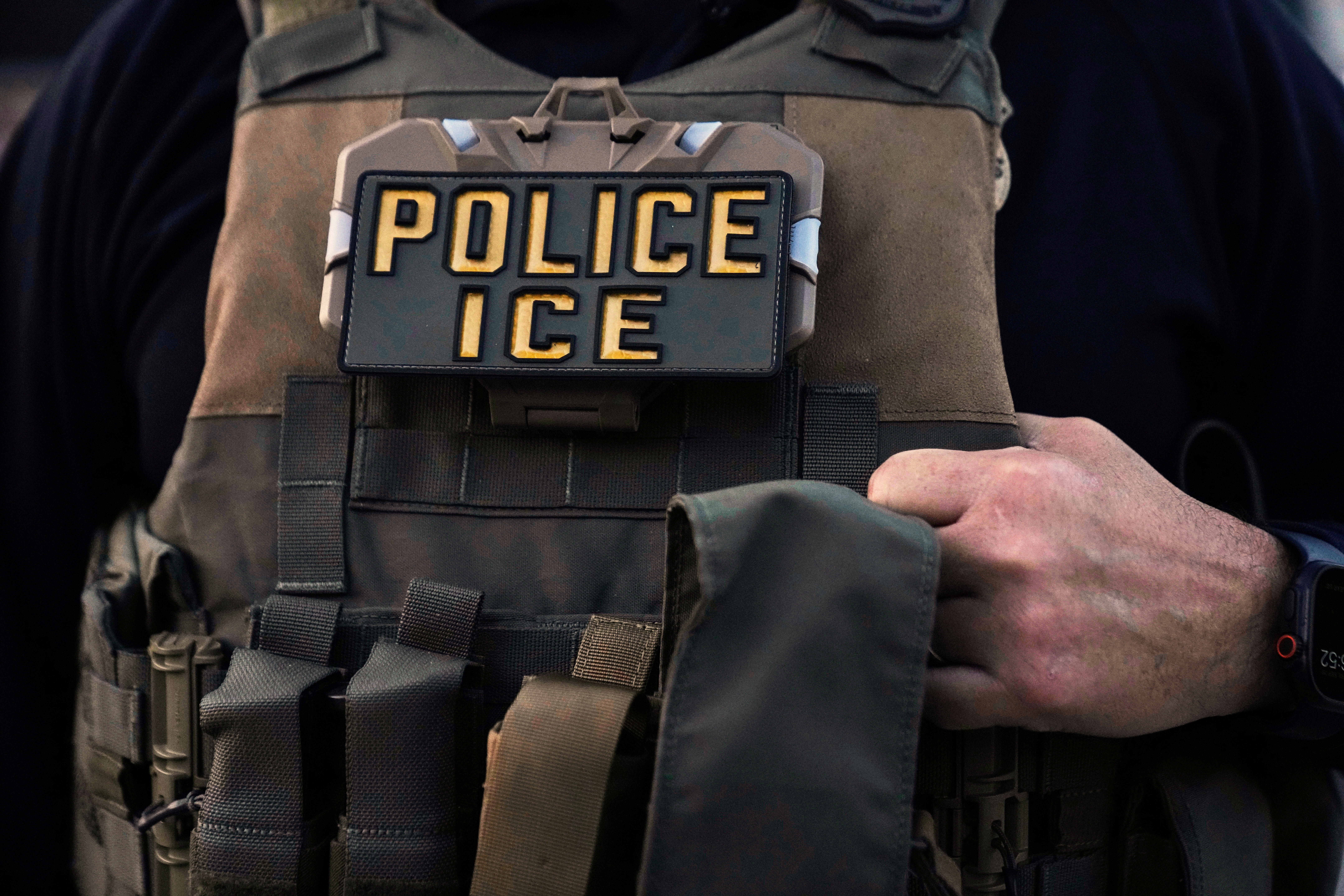 A U.S. Immigration and Customs Enforcement agent is seen in Park Ridge, Ill