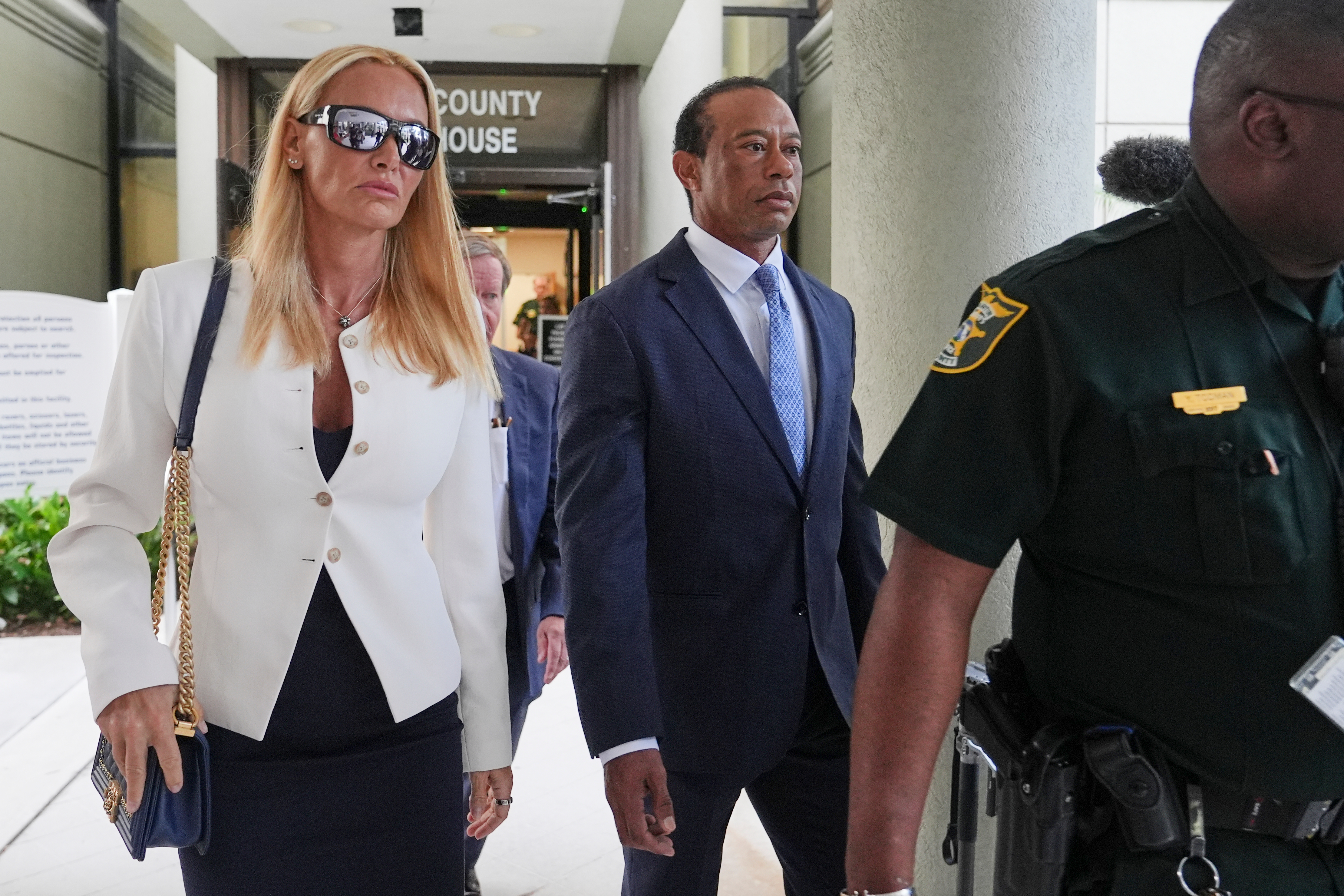 Golfer Tiger Woods leaves the court with Vanessa Trump after his plea hearing