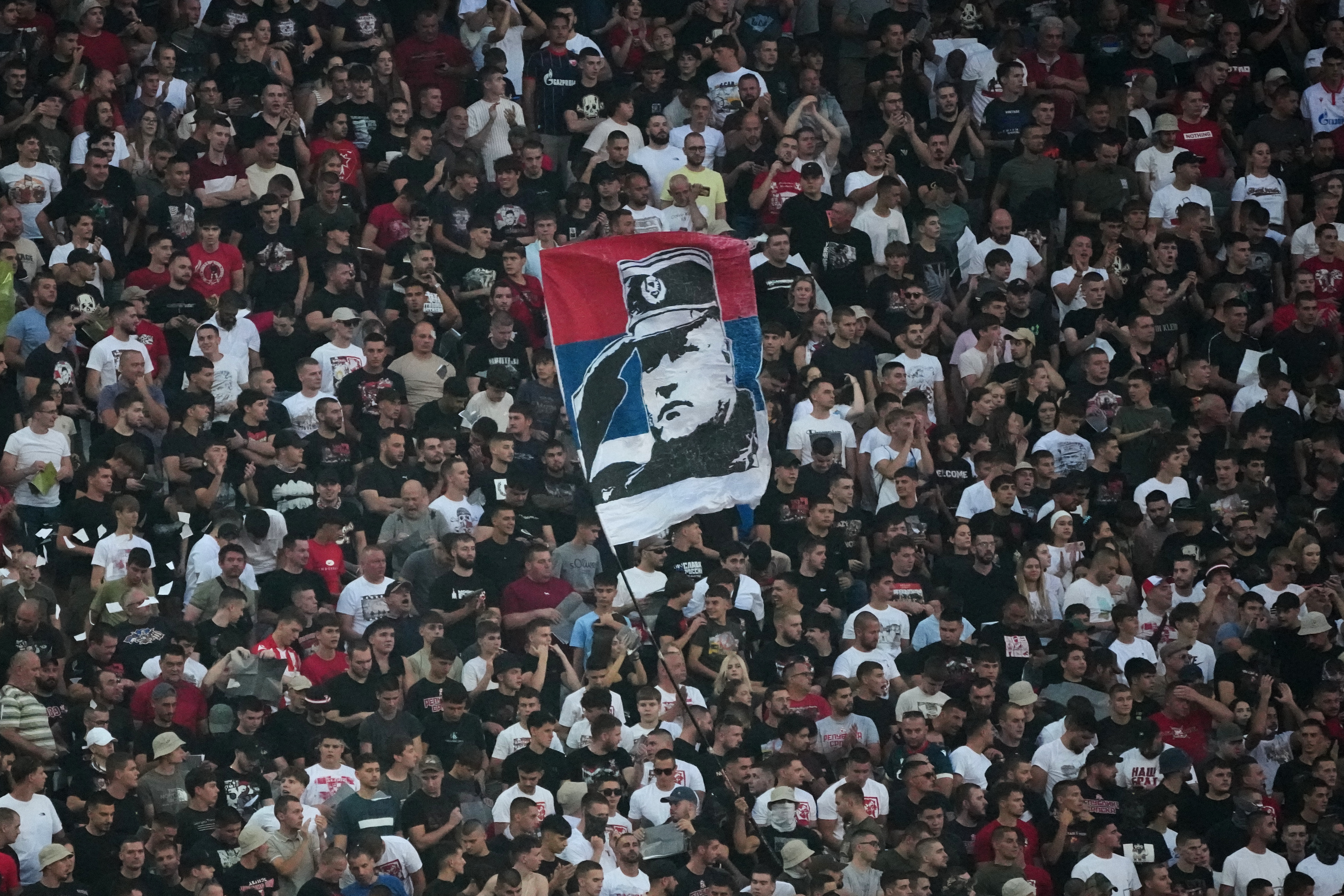 Red Star fans wave a flag shows a former Bosnian Serb wartime general Ratko Mladic during a Serbian National soccer league derby match between Red Star and Partizan in Belgrade, Serbia, Sunday, Sept. 6, 2026. (AP Photo/Darko Vojinovic)