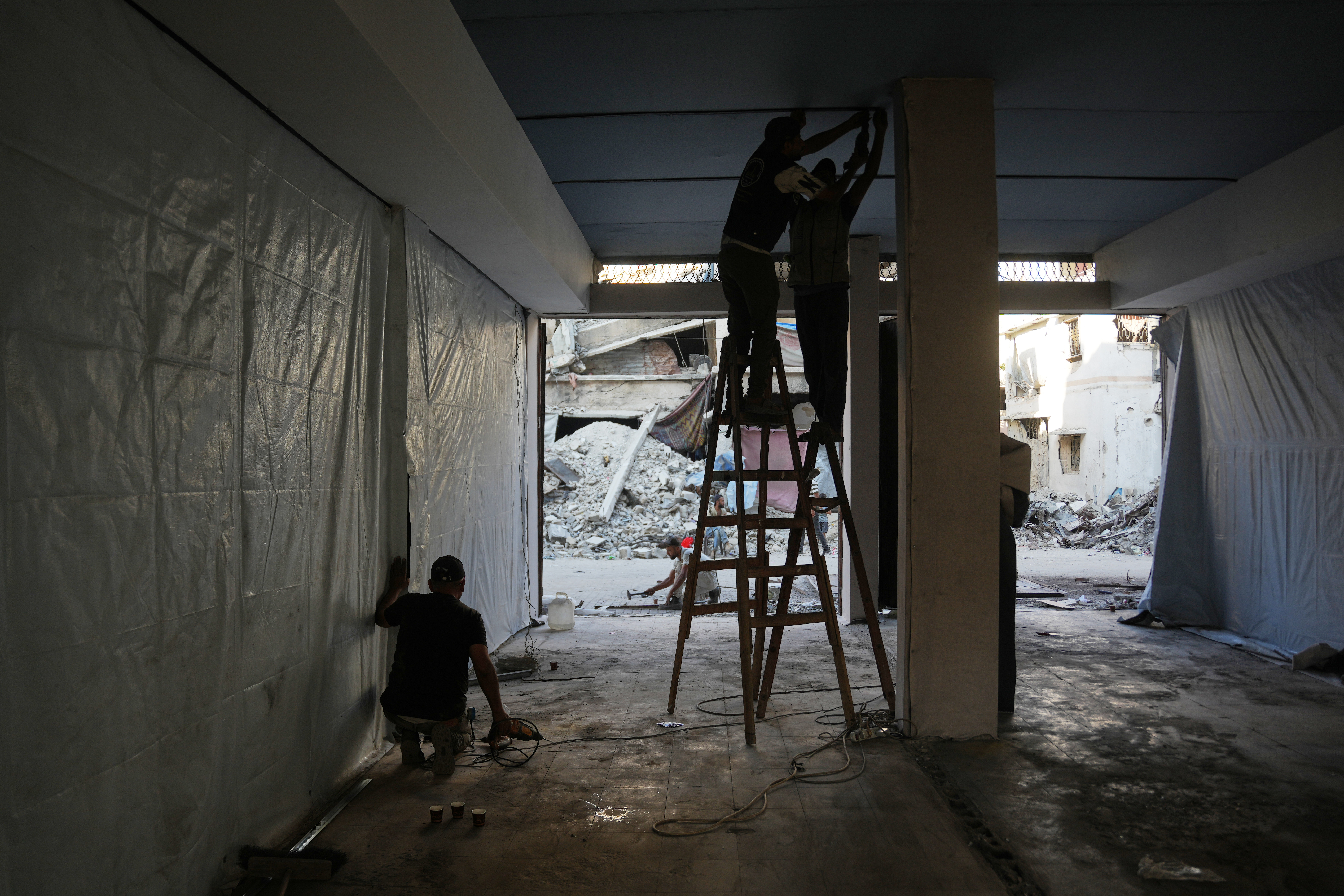 Palestinians rebuild Gaza’s ruins with mud bricks and scrap