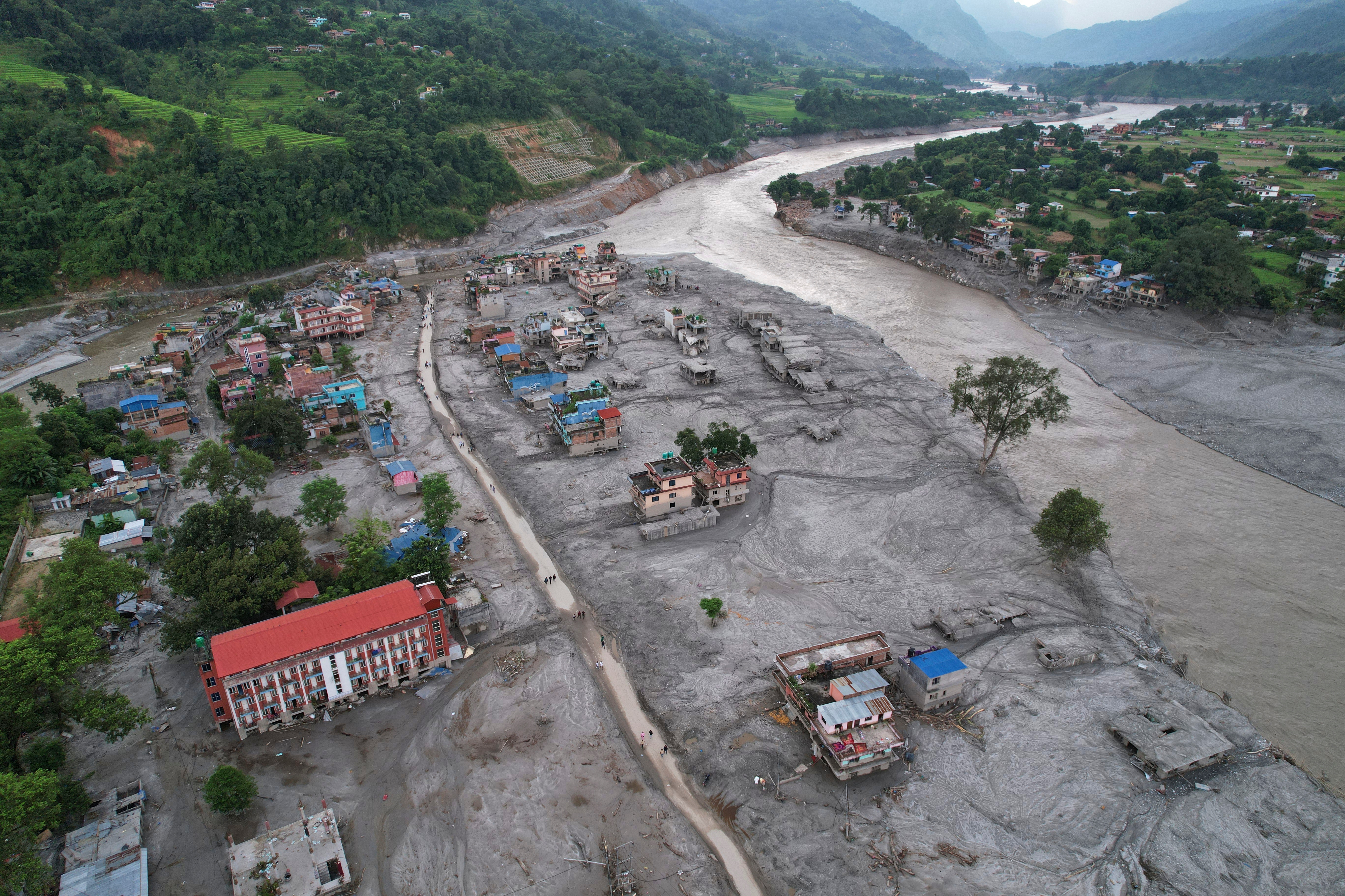Homes are engulfed in mud in the aftermath of flash flooding.