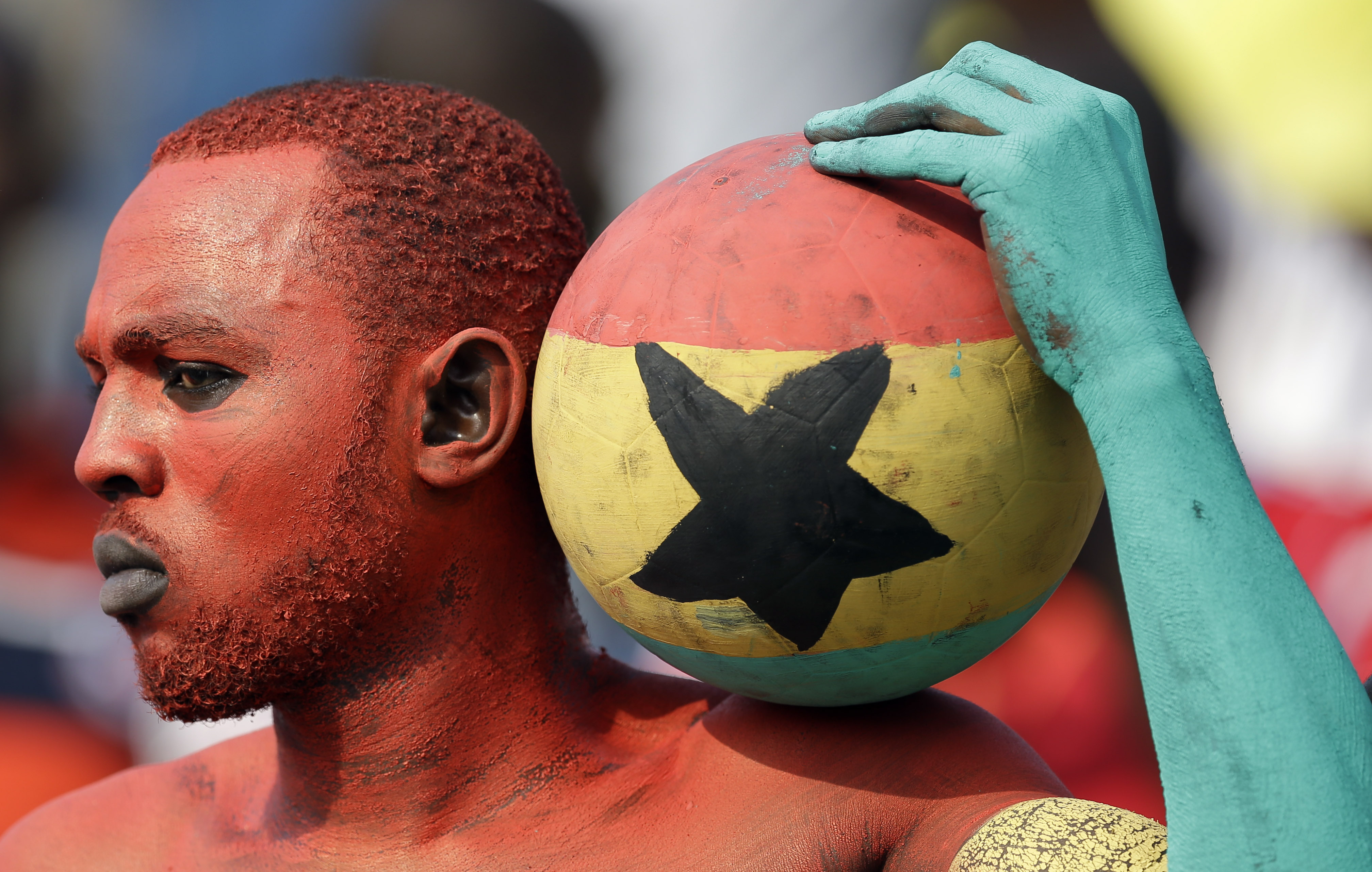 A Ghana supporter painted in his national colors attends the African Cup of Nations Group C soccer match between Algeria and Ghana in Mongomo, Equatorial Guinea, Friday, Jan. 23, 2015. (AP Photo/Themba Hadebe)