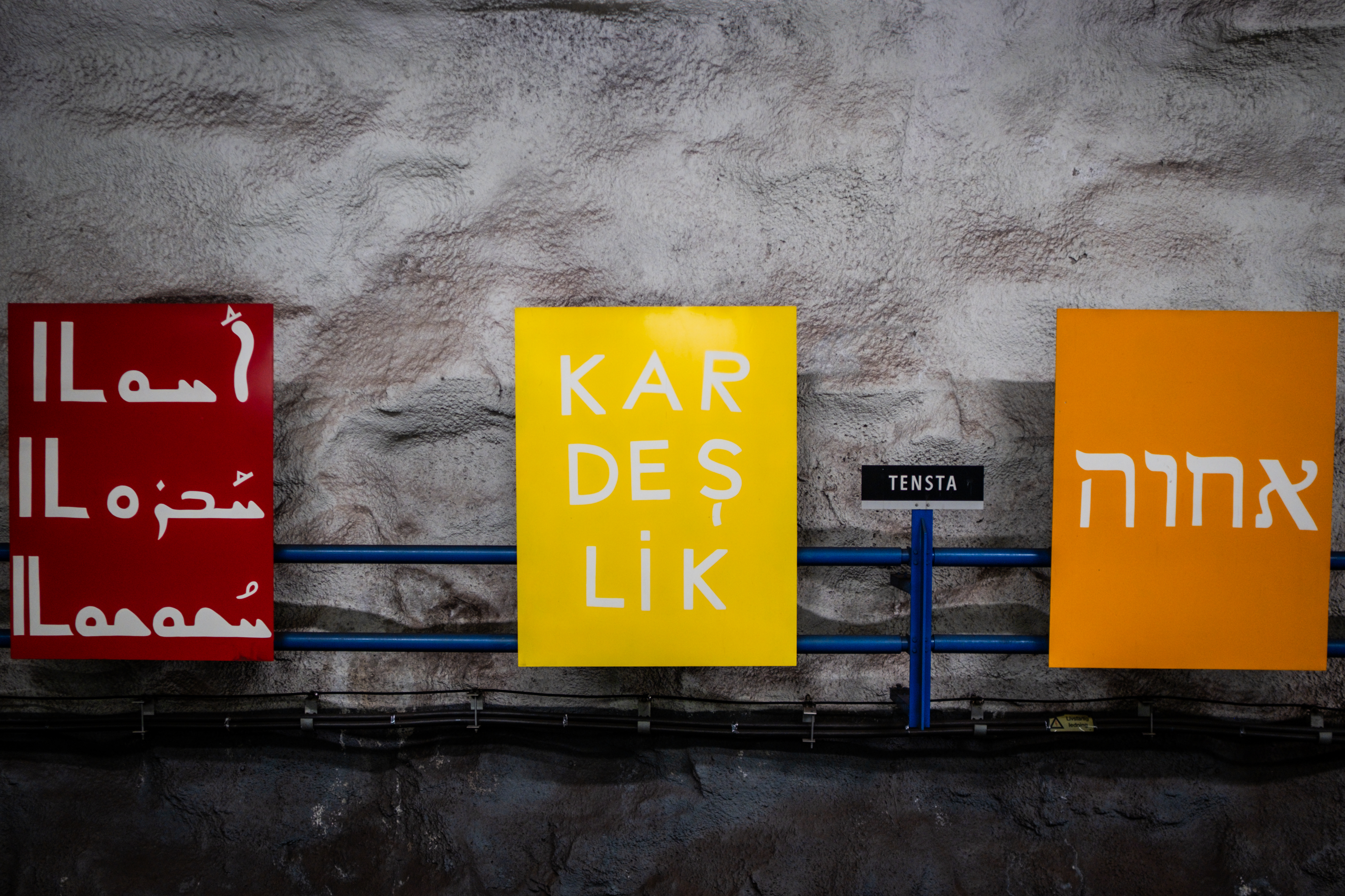 Signs celebrating Tensta’s diversity in many languages, including Arabic, Turkish and Hebrew, line the underground station