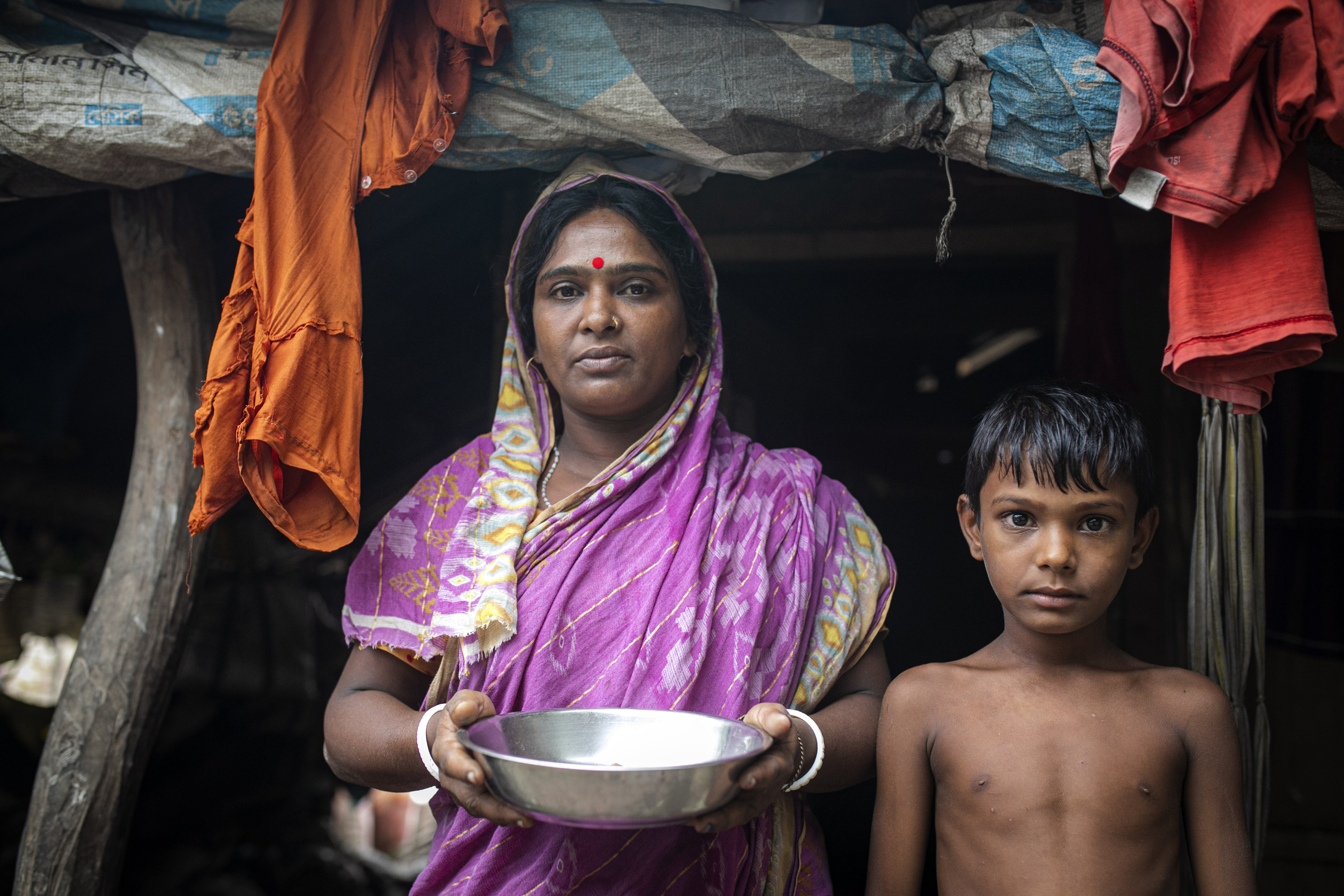 Deepa Mandol with her six-year-old son at their home in Koyra