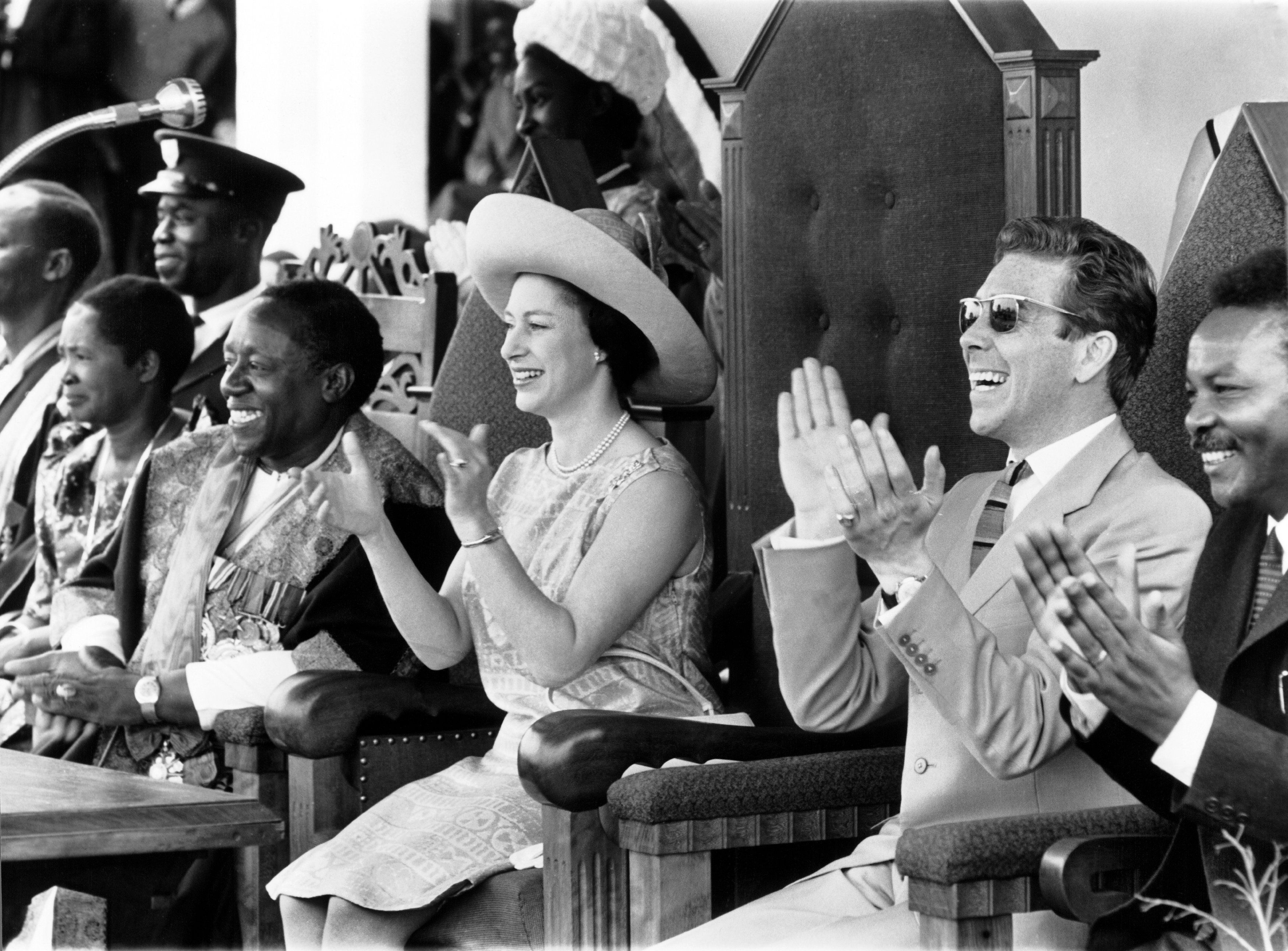 Princess Margaret and her husband, Lord Snowdon, attend a performance by Ugandan indigenous dancers during their official visit to Uganda on March 17, 1965 [Keystone-France/Gamma-Keystone via Getty Images]