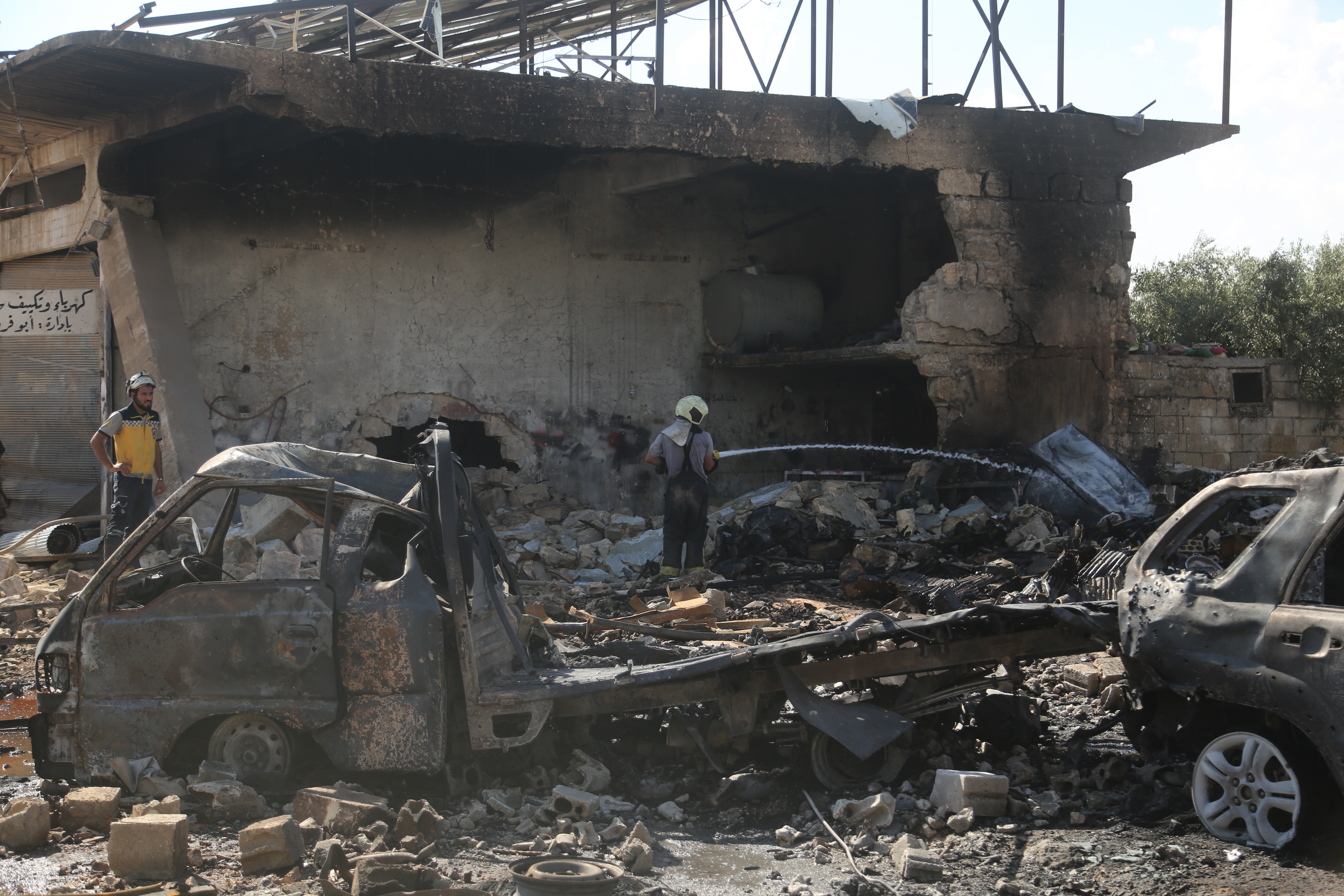 he explosion heavily damages nearby buildings and vehicles after an ammunition-laden vehicle explodes in Syriaâs northwestern Idlib province
