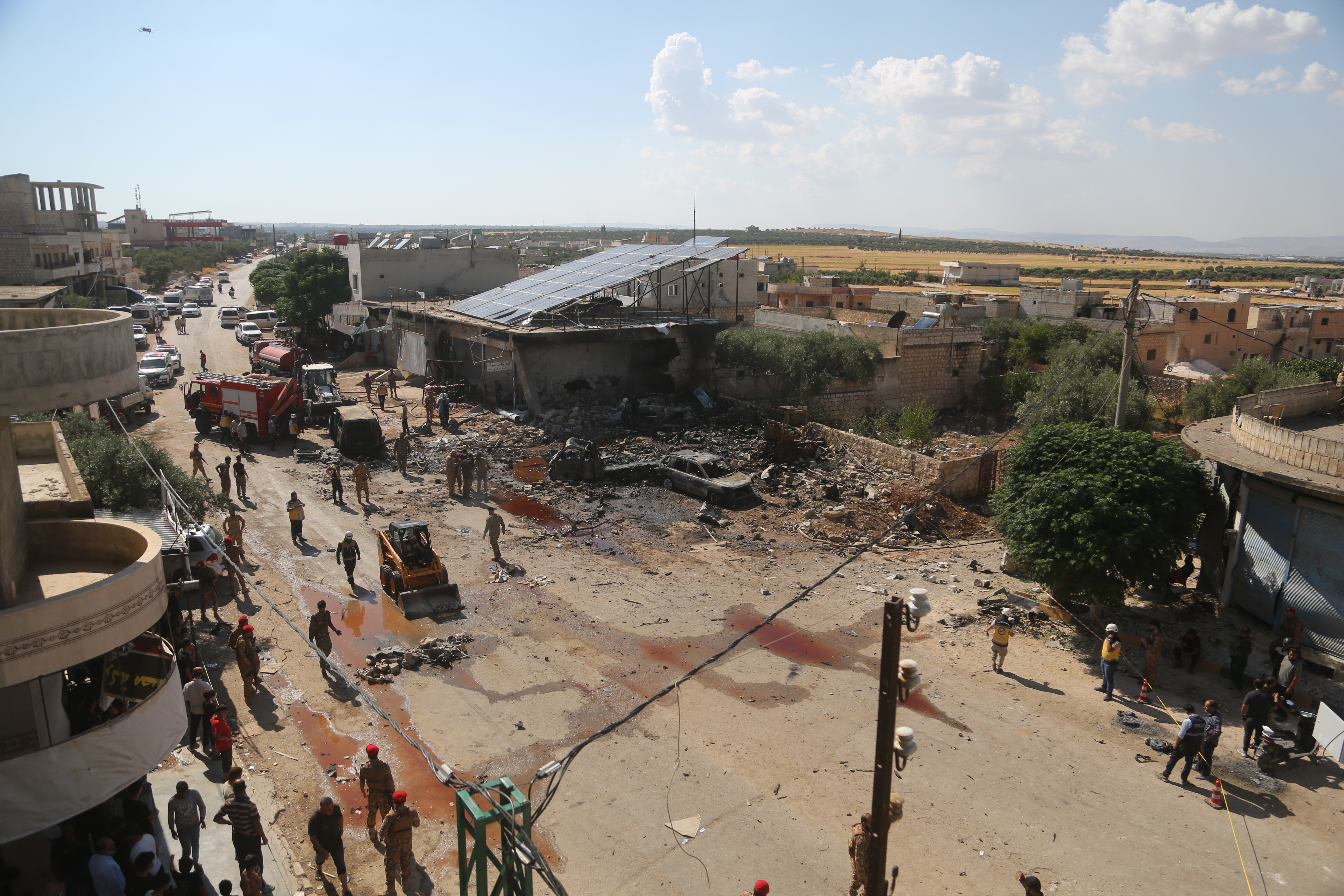 he explosion heavily damages nearby buildings and vehicles after an ammunition-laden vehicle explodes in Syriaâs northwestern Idlib province