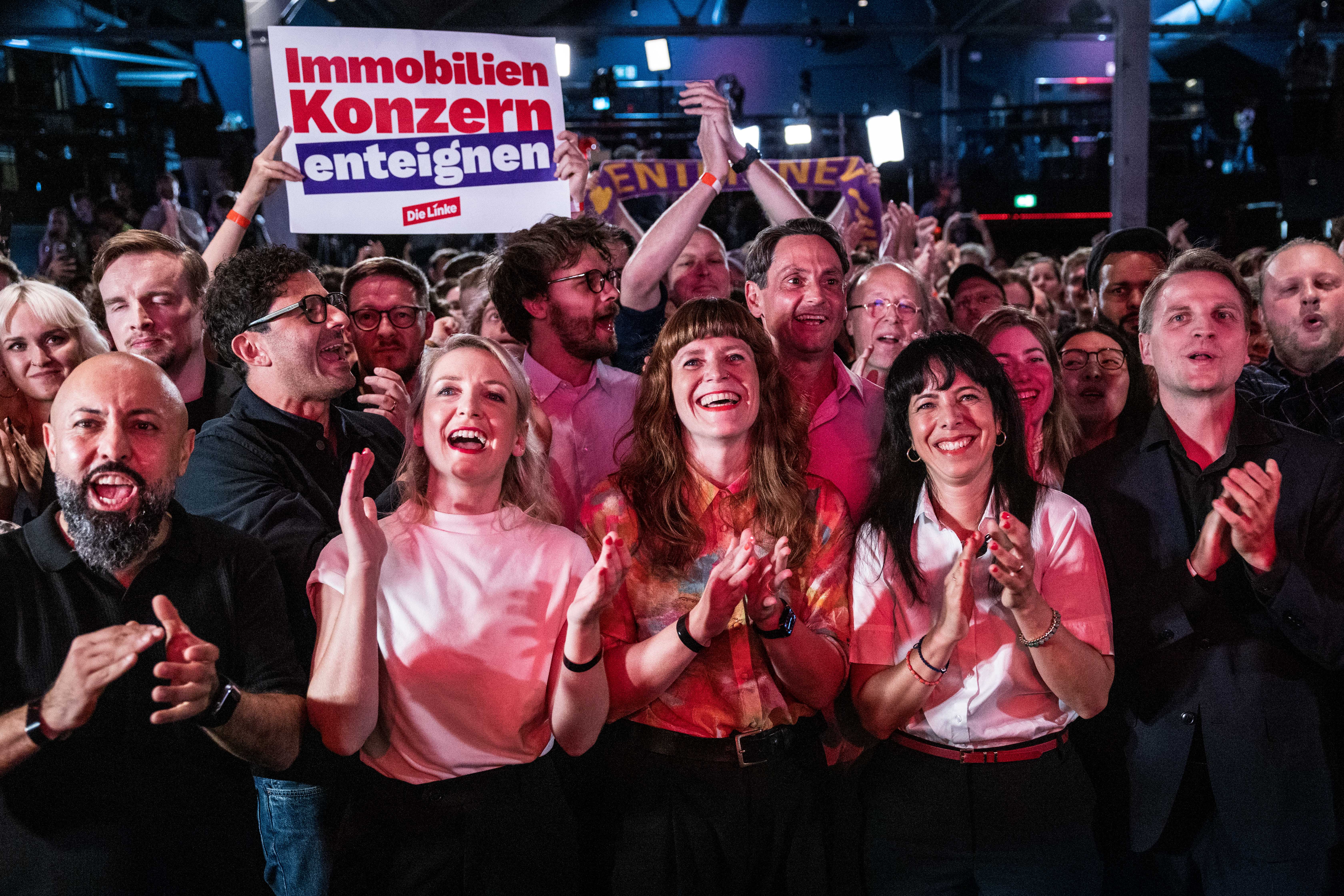 Die Linke supporters react as preliminary results are announced in Berlin