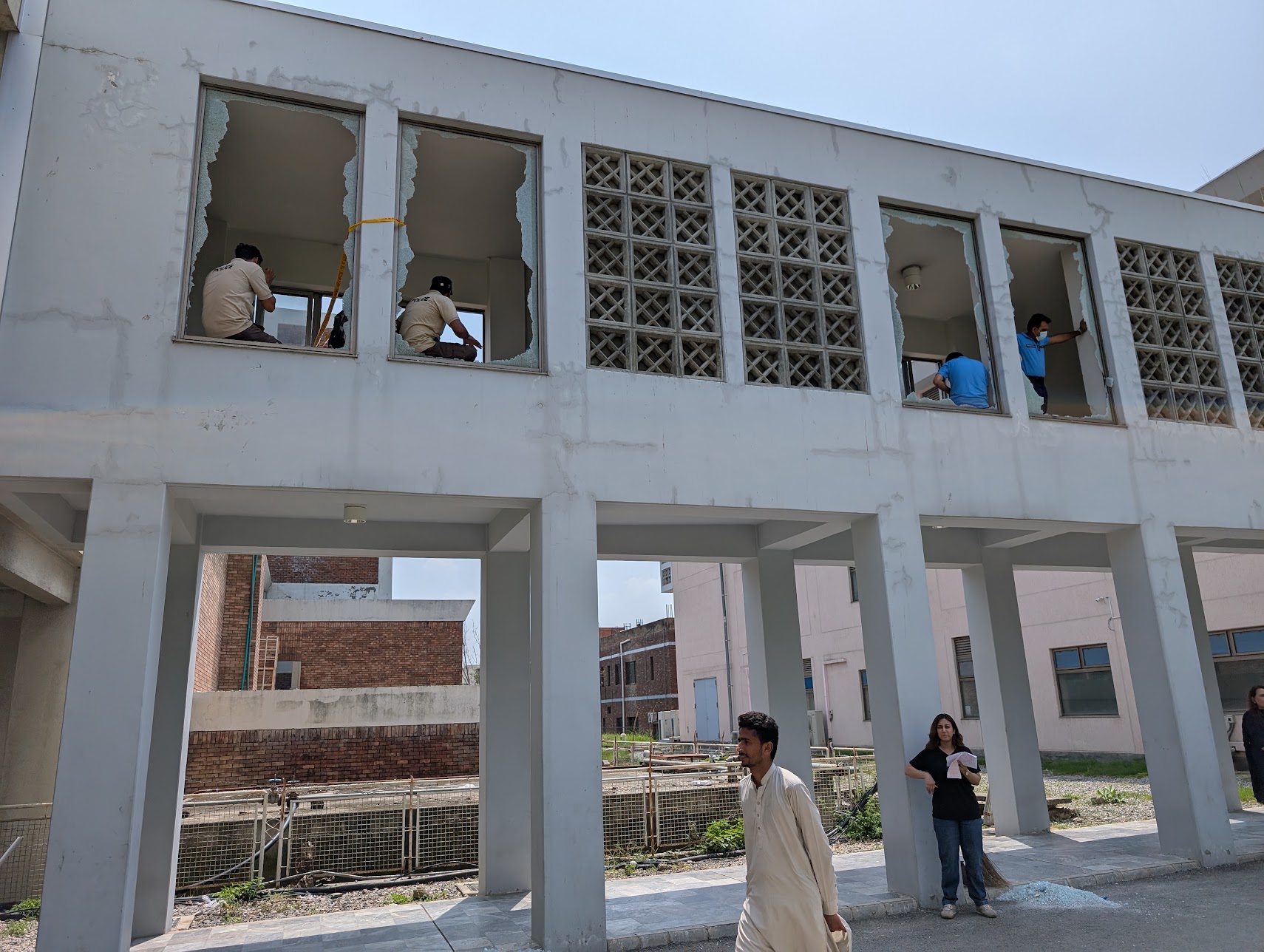 Broken windows at the PIMS building housing the nursery, hours after the August 26 fire. [Abid Hussain/Al Jazeera]
