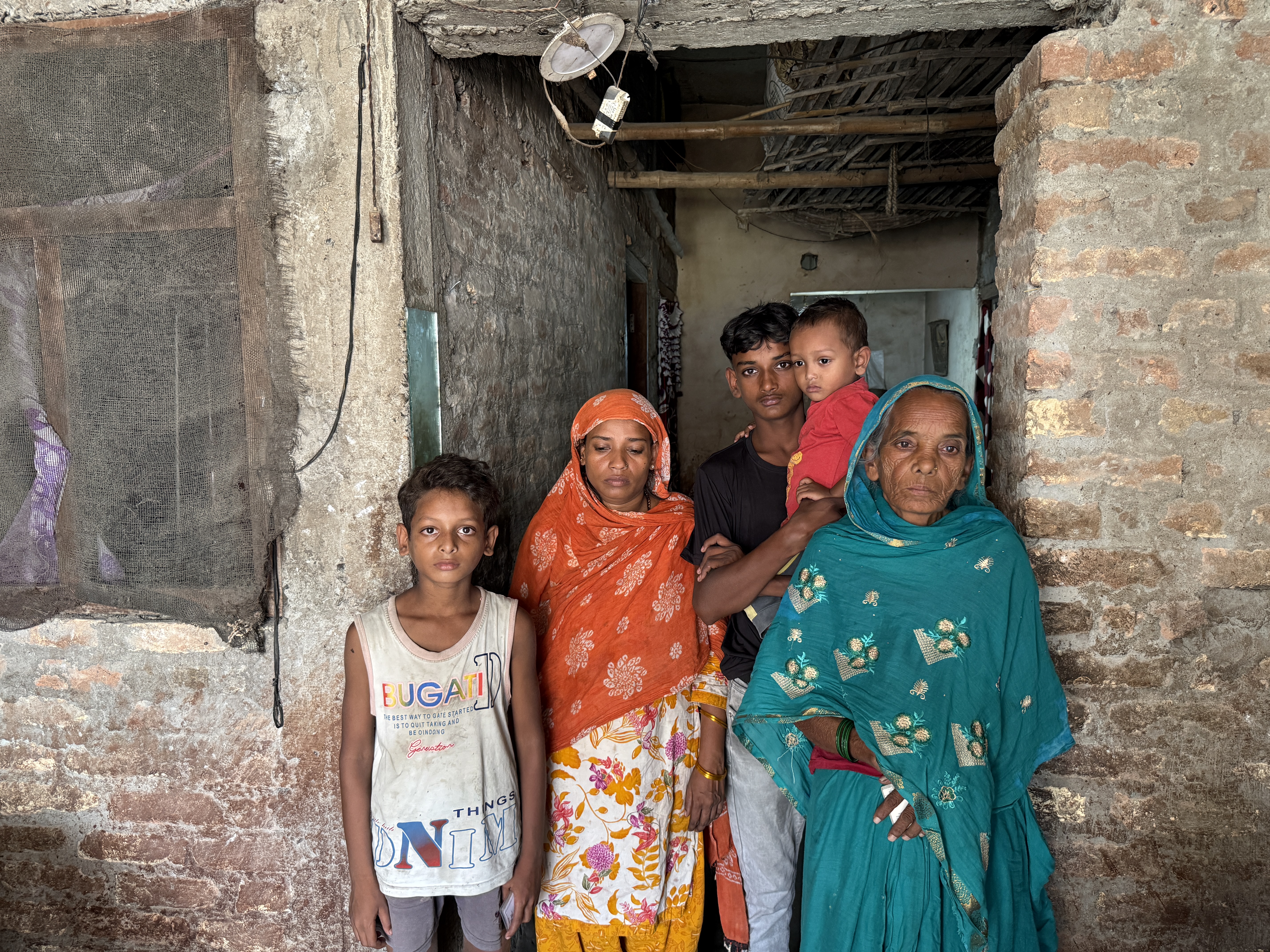Sahrun Khatun, Arman’s wife, with her eldest son Salman (holding the youngest child) who survived, her mother-in-law, and two younger children, outside their home in Turhapatti, Bihar, India