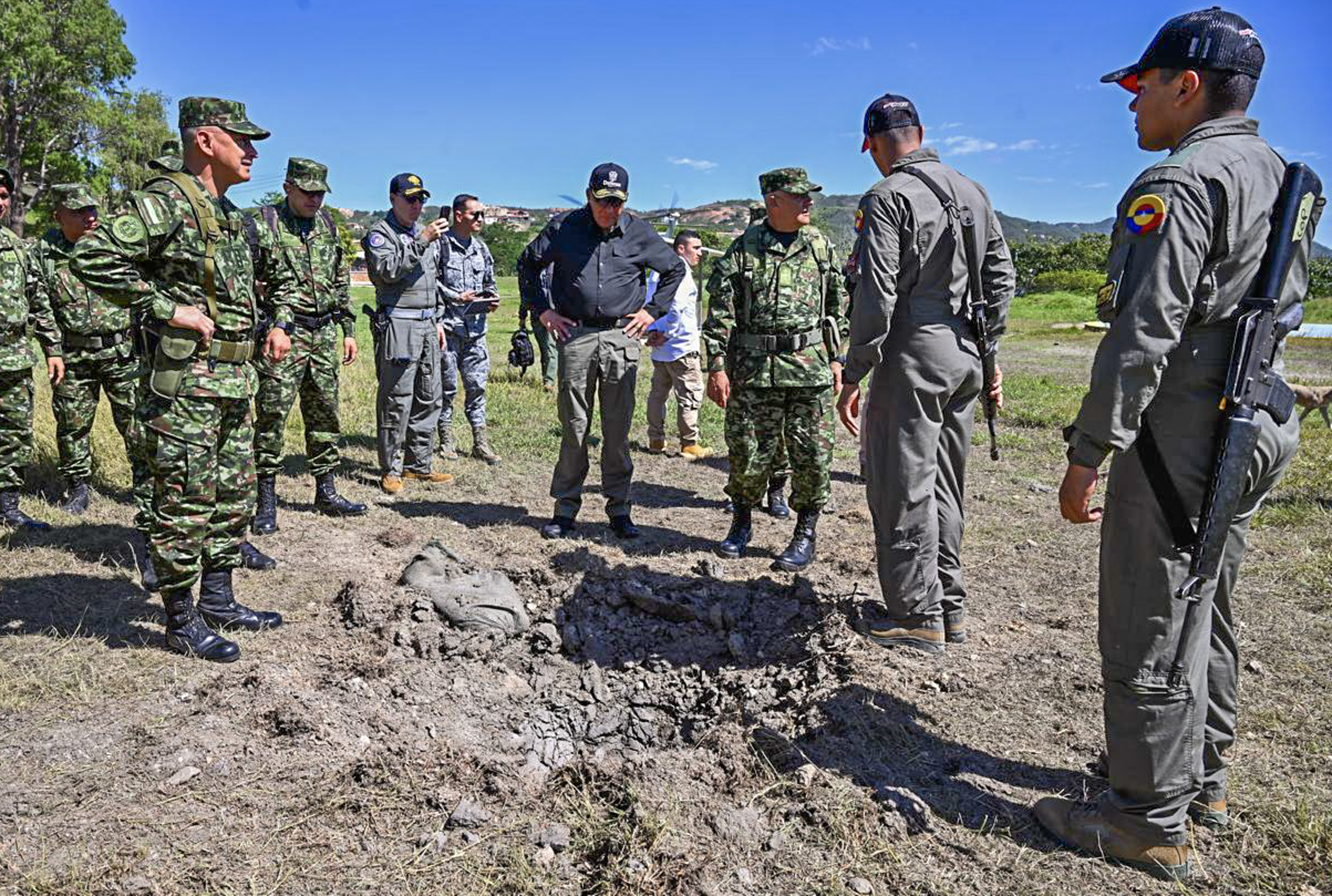 Handout picture released by Colombia's Ministry of Defense press office showing Minister of Defense Jorge Mora (C) looking at the site of a guerrilla drone attack, at a military garrison in Ocana, Department of Norte de Santander, Colombia, on September 5, 2026.