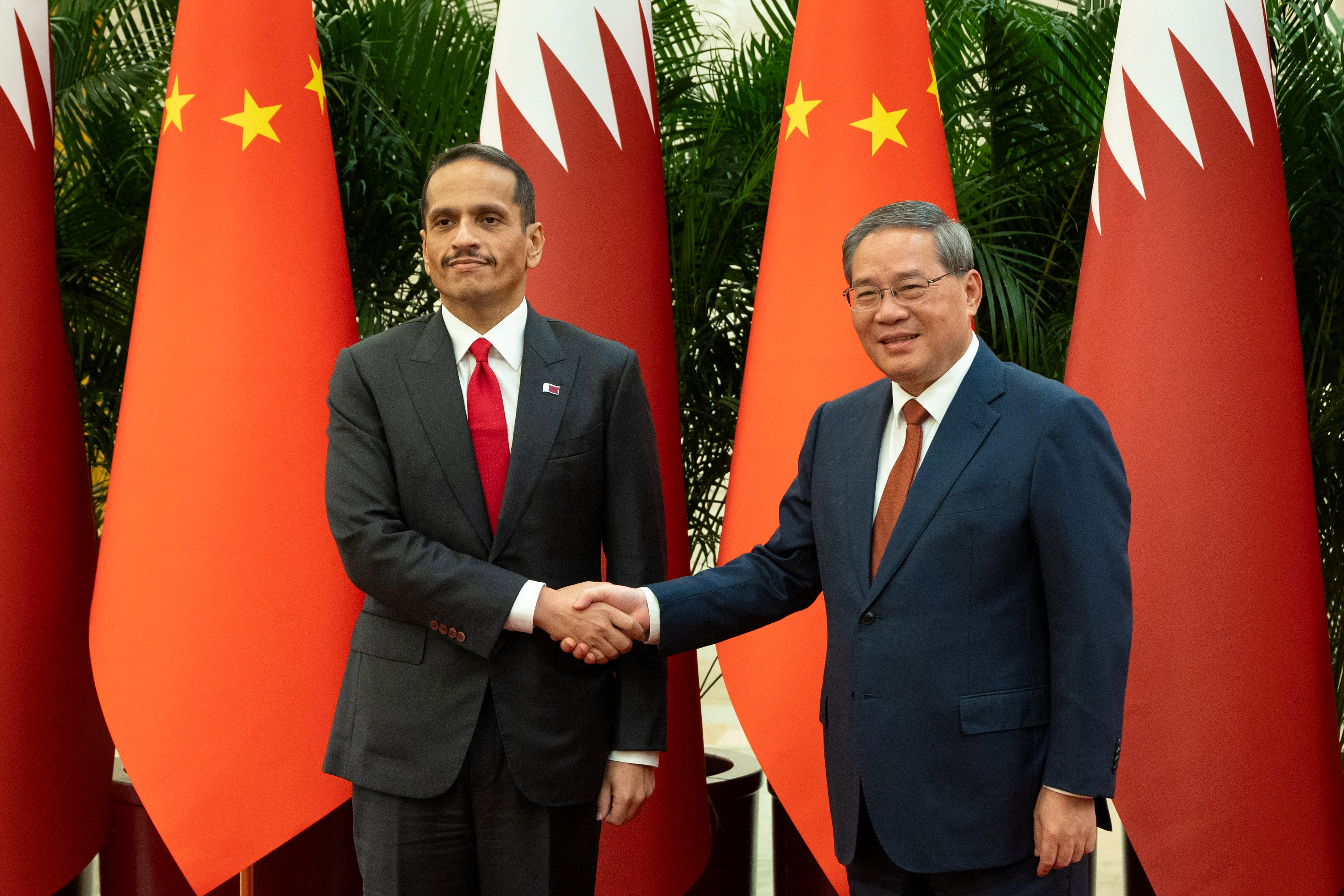This handout photograph released by the Qatari Ministry of Foreign Affairs on September 7, 2026 shows Qatar's Prime Minister and Foreign Minister Sheikh Mohammed bin Abdulrahman bin Jassim Al-Thani (L) shaking hands with Chinese Premier Li Qiang before their meeting in Beijing.