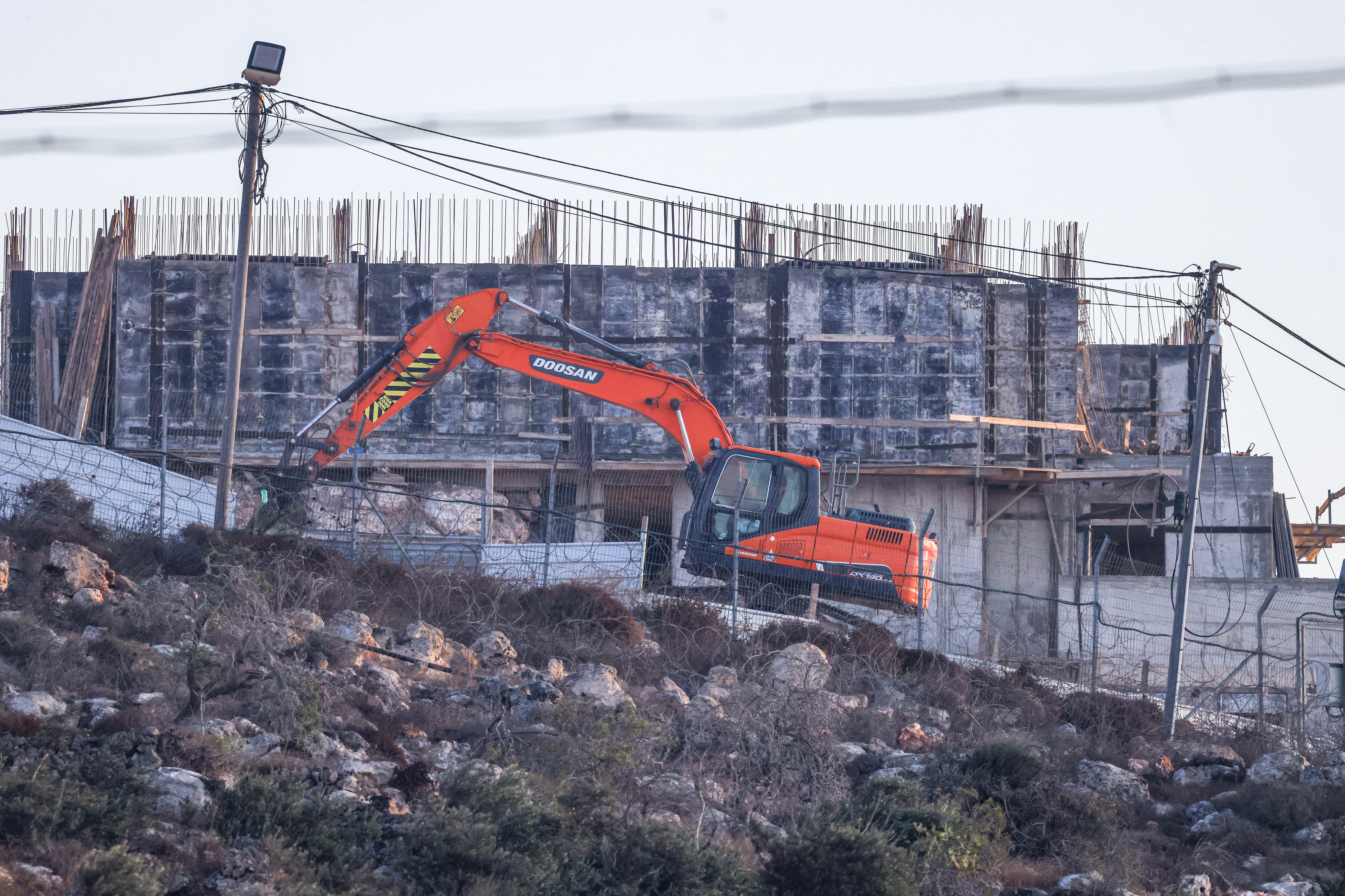An Israeli bulldozer works near the Israeli settlement of Migdalim, close to the Palestinian village of Qusra, south of the city of Nablus in the Israeli-occupied West Bank, on September 6, 2026.