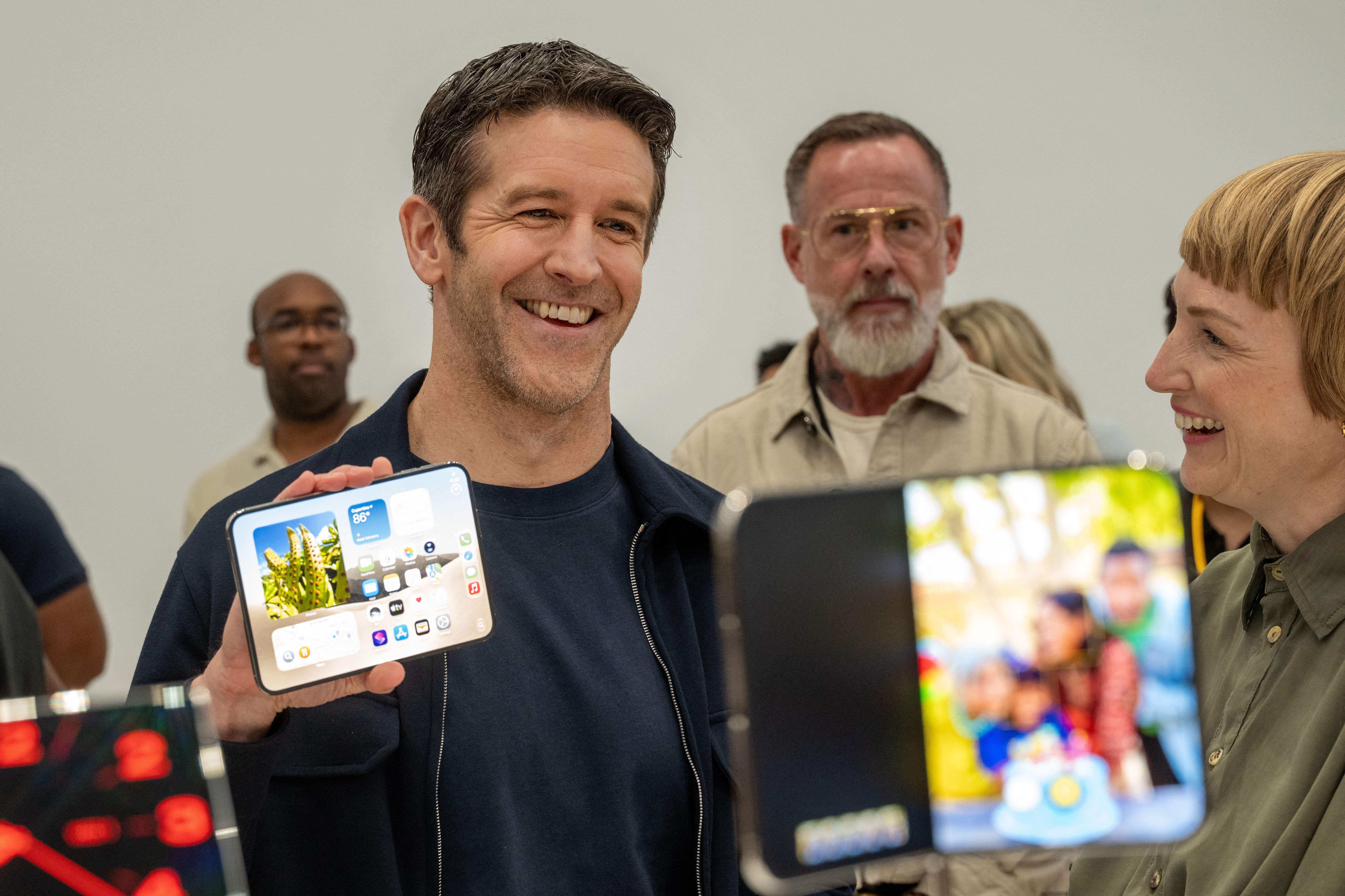 New Apple CEO John Ternus, alongside vice president of industrial Molly Anderson, shows off an iPhone Duo during an Apple event at the Steve Jobs Theater in Apple Park in Cupertino, California, on September 9, 2026.