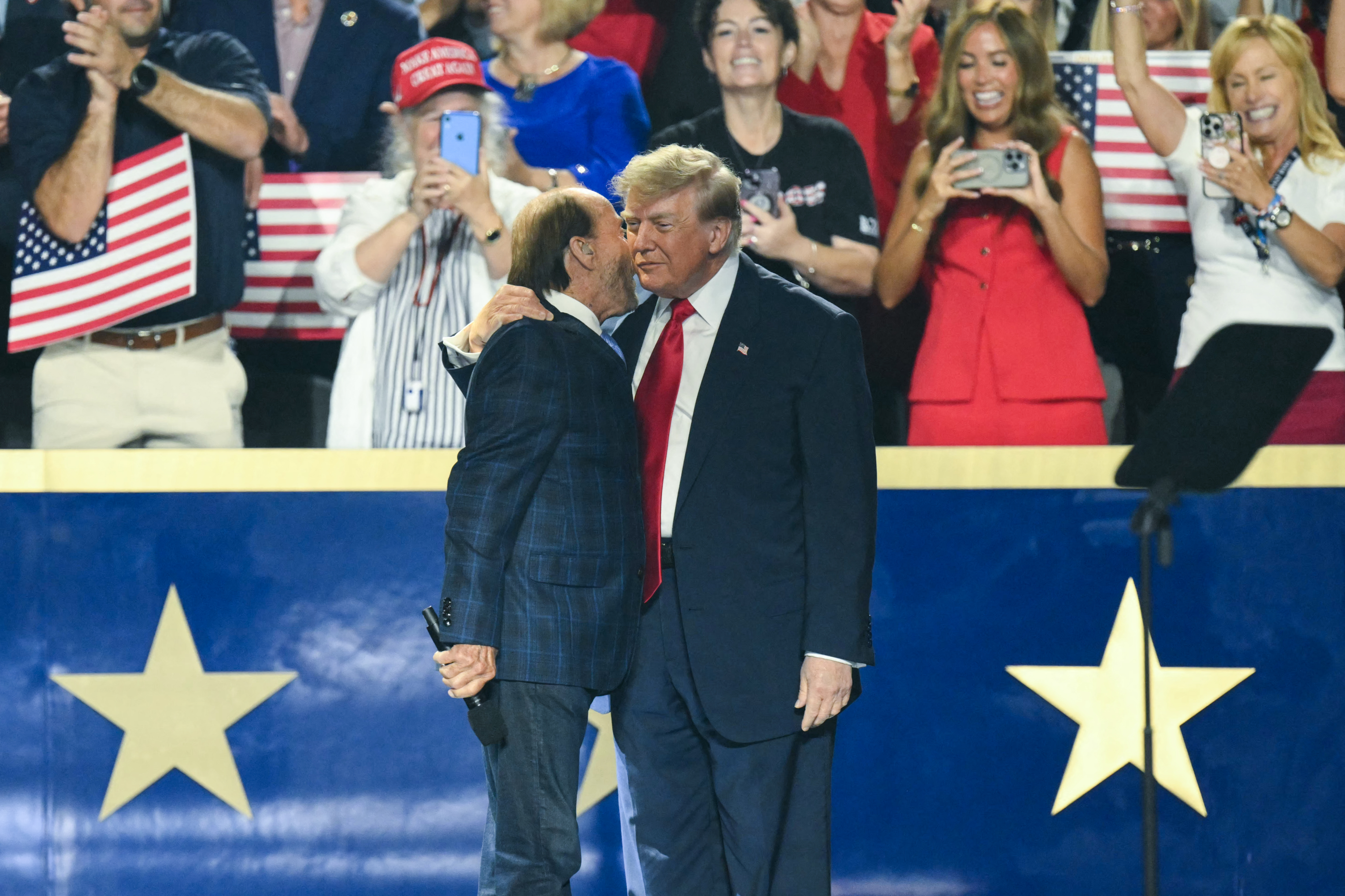 US President Donald Trump greets US singer Lee Greenwood before speaking during the second day of the Republican National Committee midterm convention at the American Airlines Center in Dallas, Texas on September 10, 2026.