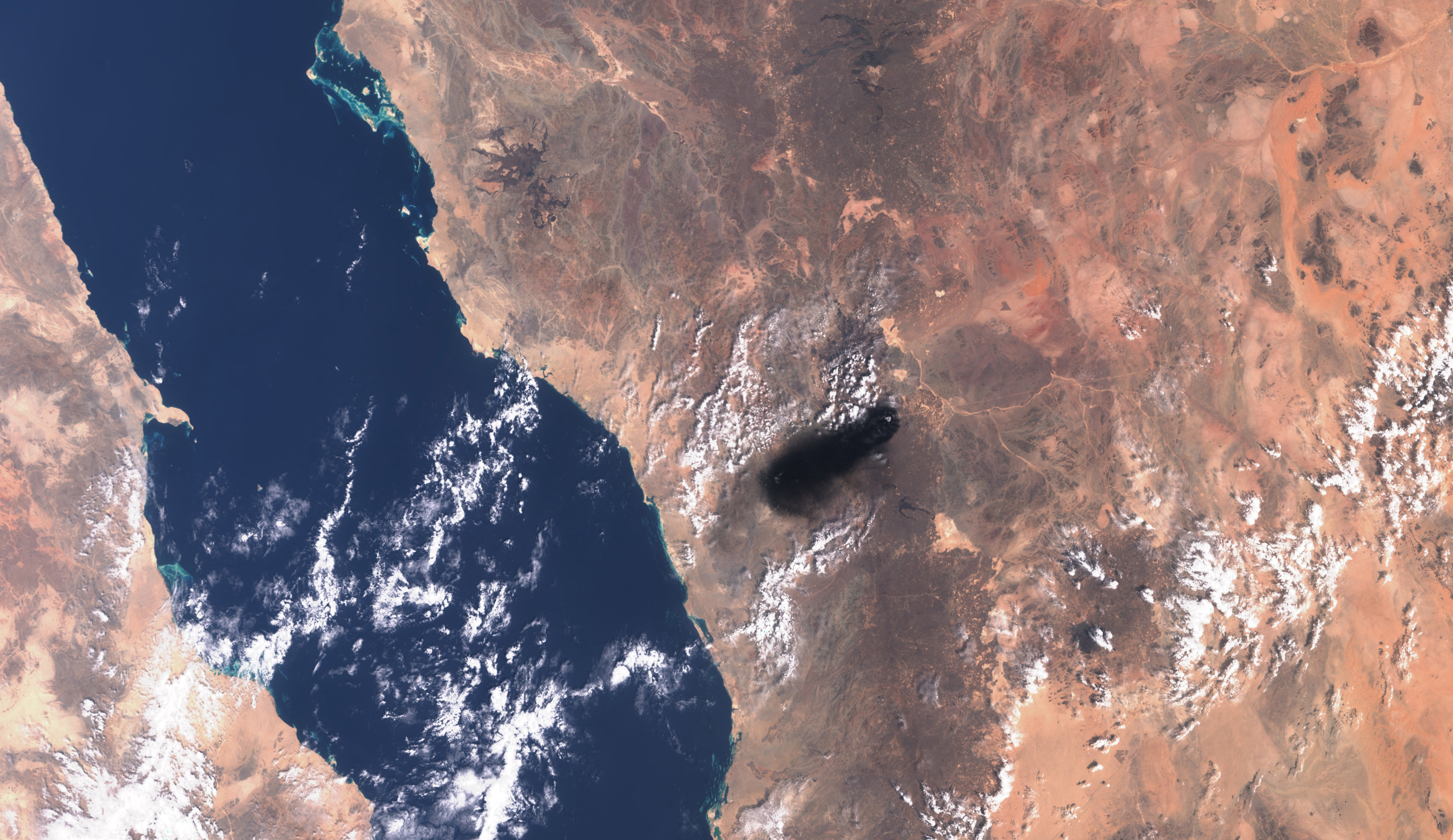 This handout satellite image from Copernicus Sentinel Data taken on September 10, 2016, shows black smoke billowing over the desert southeast of Medina along the general route of Saudi Arabia's East-West pipeline (Petroline).