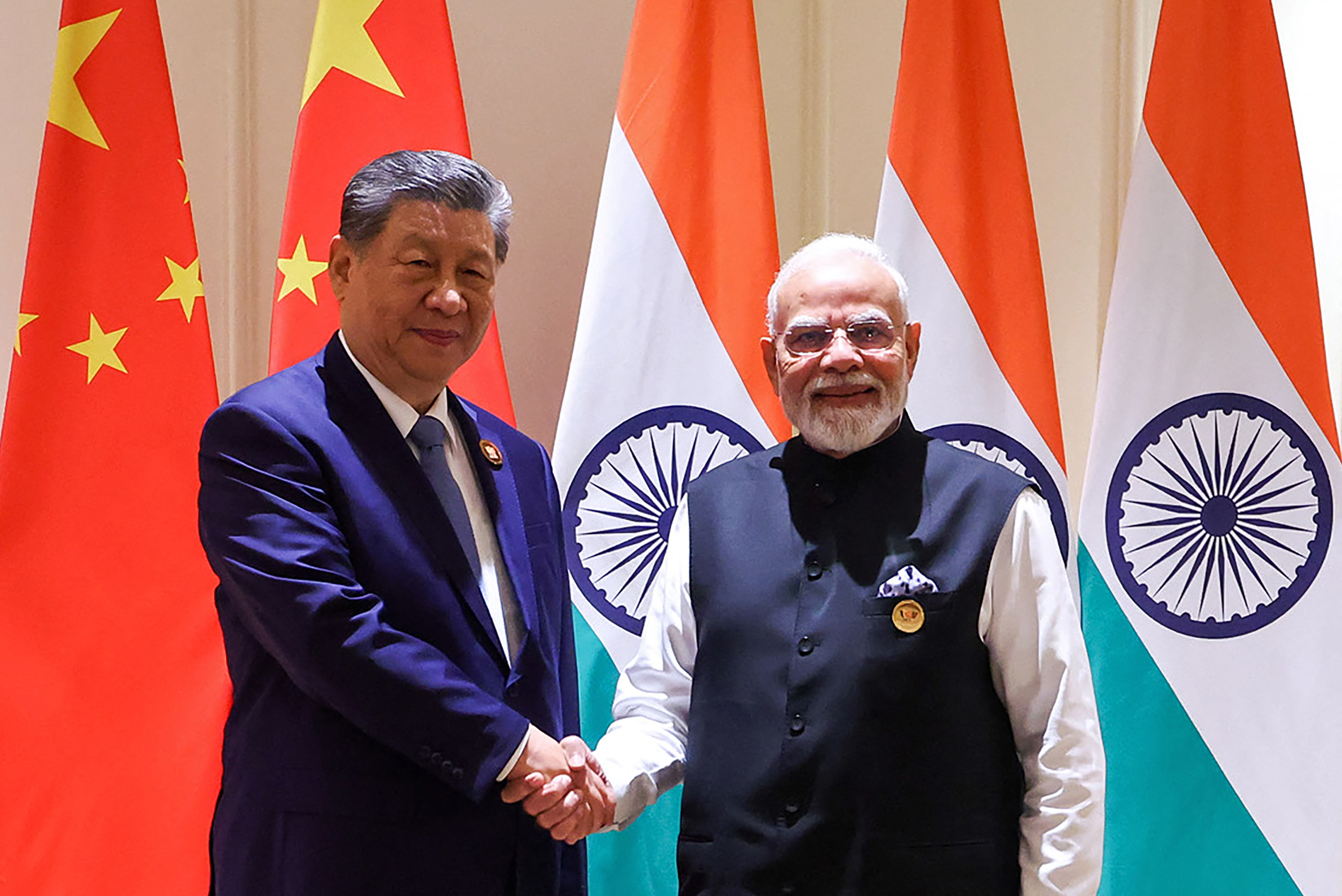 This handout photograph taken on September 12, 2026 and released by the Indian Press Information Bureau (PIB) shows India's Prime Minister Narendra Modi (R) and China's President Xi Jinping shaking hands during a bilateral meeting on the sidelines of the 18th BRICS Summit at the Bharat Mandapam in New Delhi on September 12, 2026.