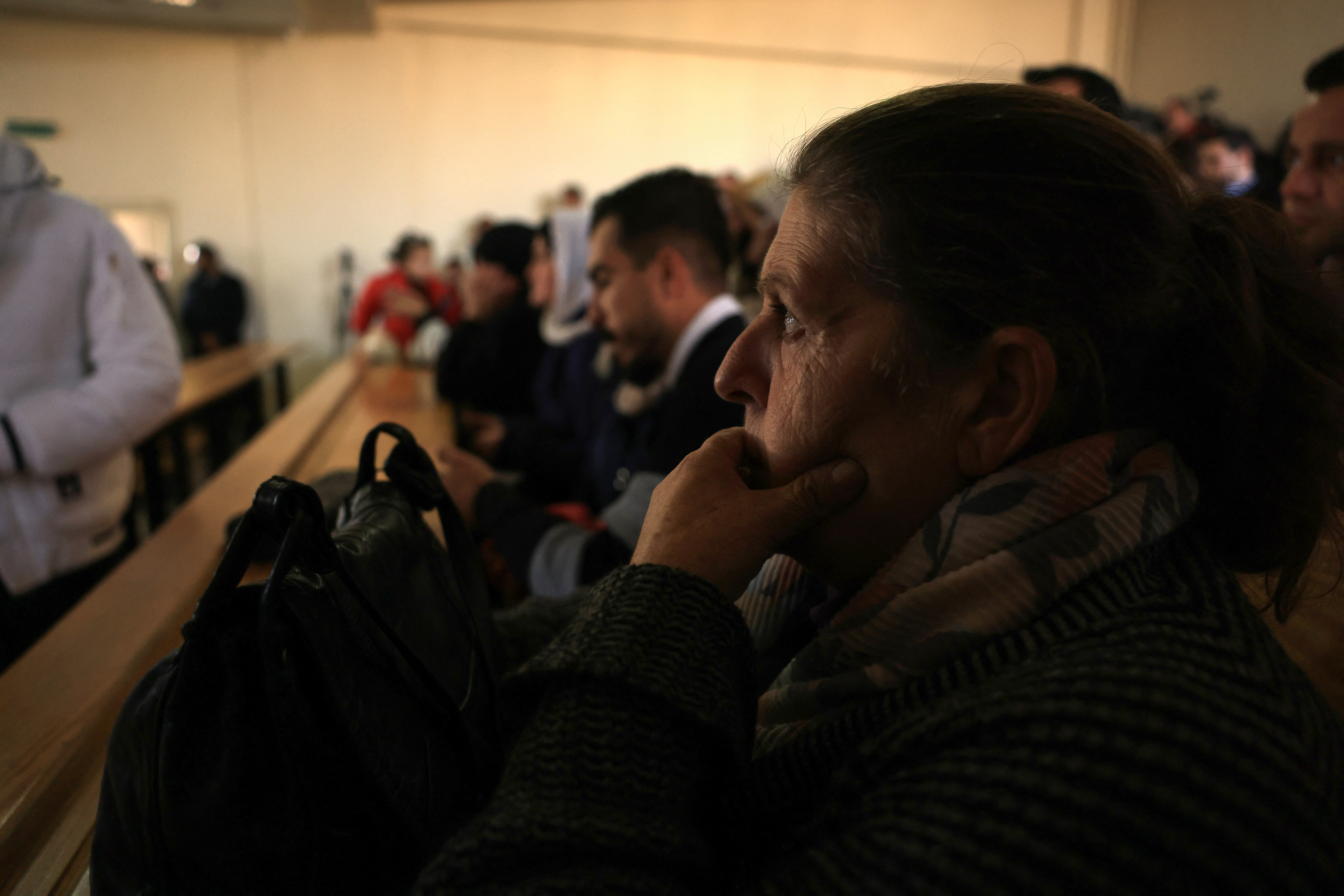 (FILES) People attend the first trial of more than a dozen suspects linked to massacres that left hundreds dead in Syria's Alawite coastal heartland earlier this year, at the Justice Palace in Aleppo on November 18, 2025.