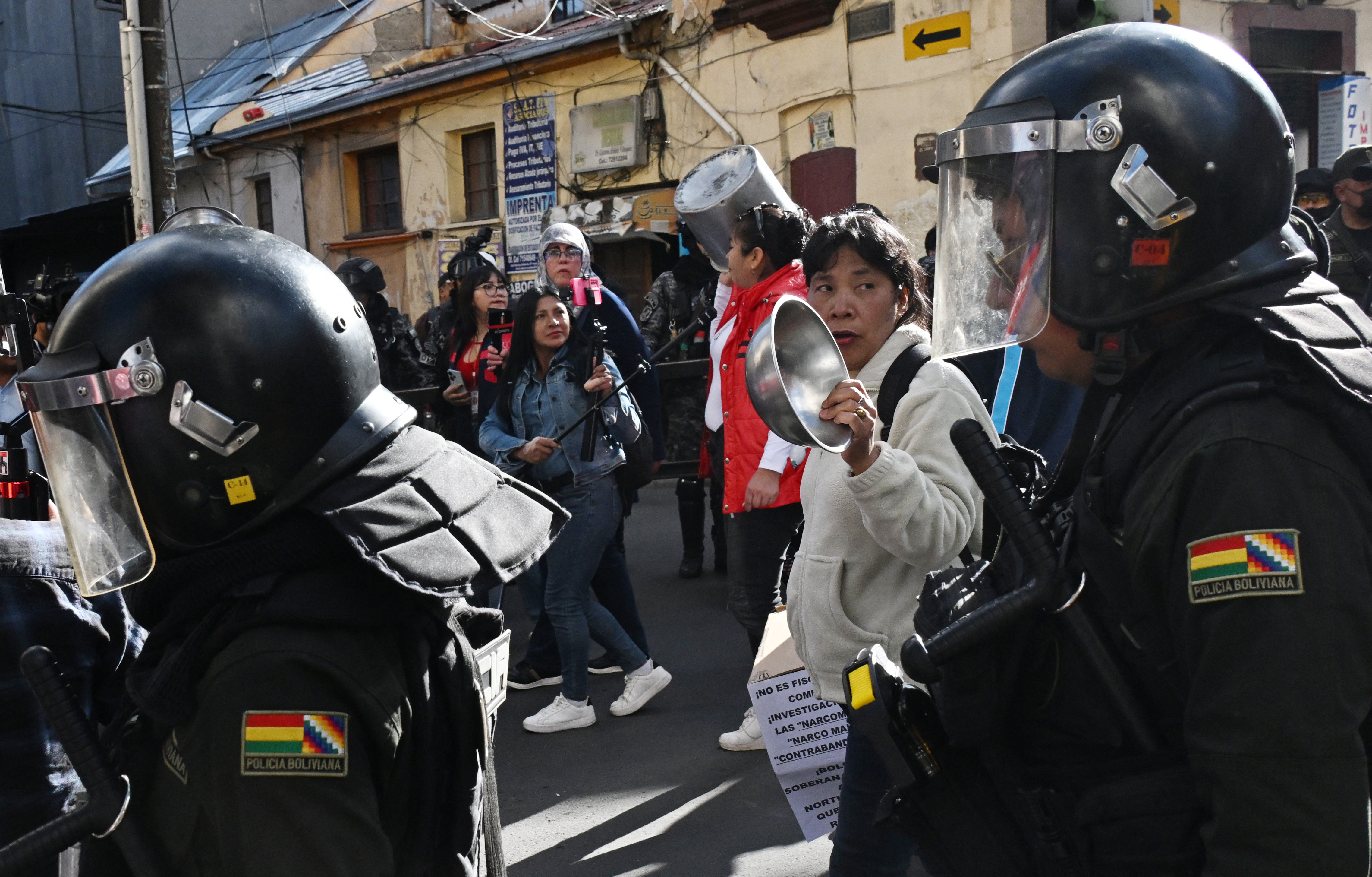 Bolivian police officers stand guard at a protest by education workers against the Bolivian government in La Paz on September 15, 2026