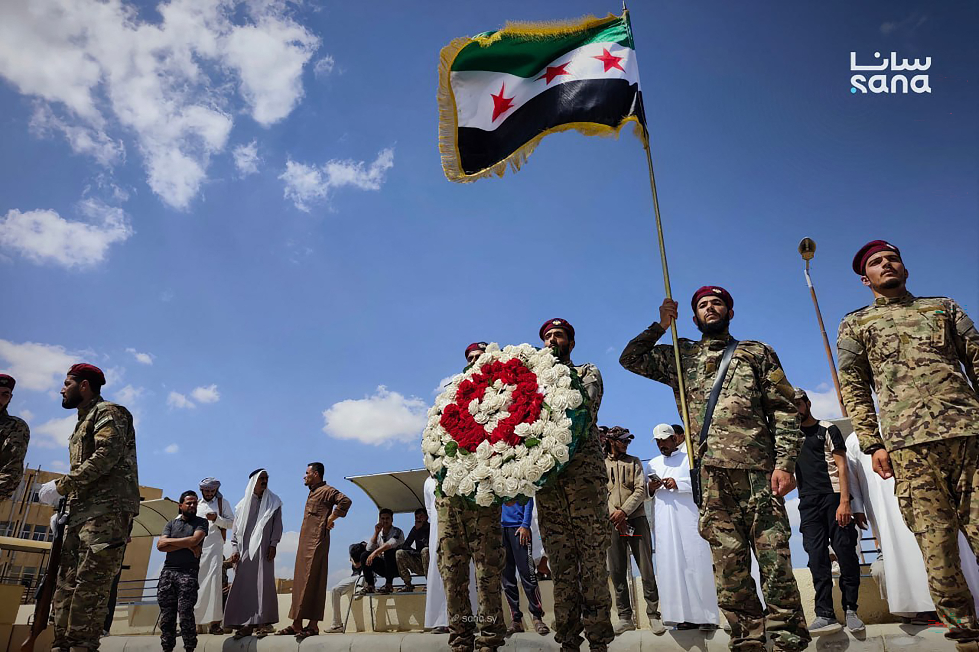 This handout picture taken and released by the official Syrian Arab News Agency (SANA) on September 19, 2026 shows Syrian soldiers and mourners attending a funeral procession for people who were killed in an explosion that took place the day before at the Ayyash area, at the National Hospital in Deir Ezzor.