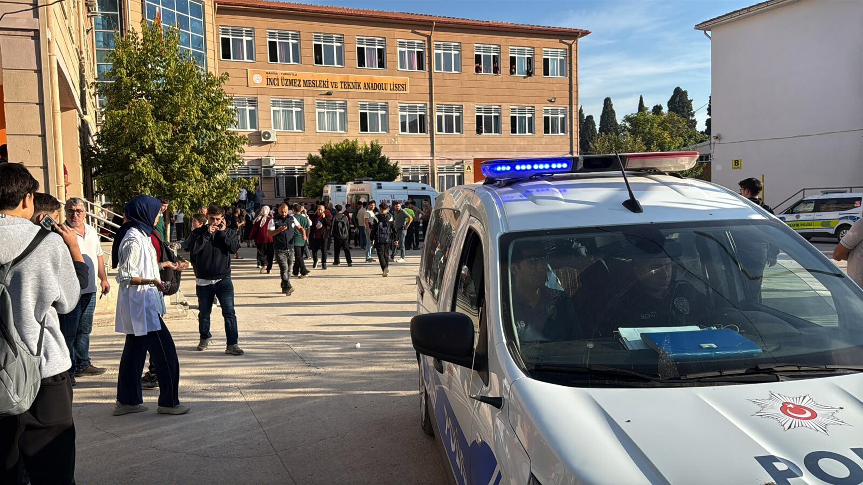 Ambulances and police officers waiting in front of a high school outside which a man opened fire wounding eight people, and was arrested shortly afterwards, in Turgutlu, Turkiye