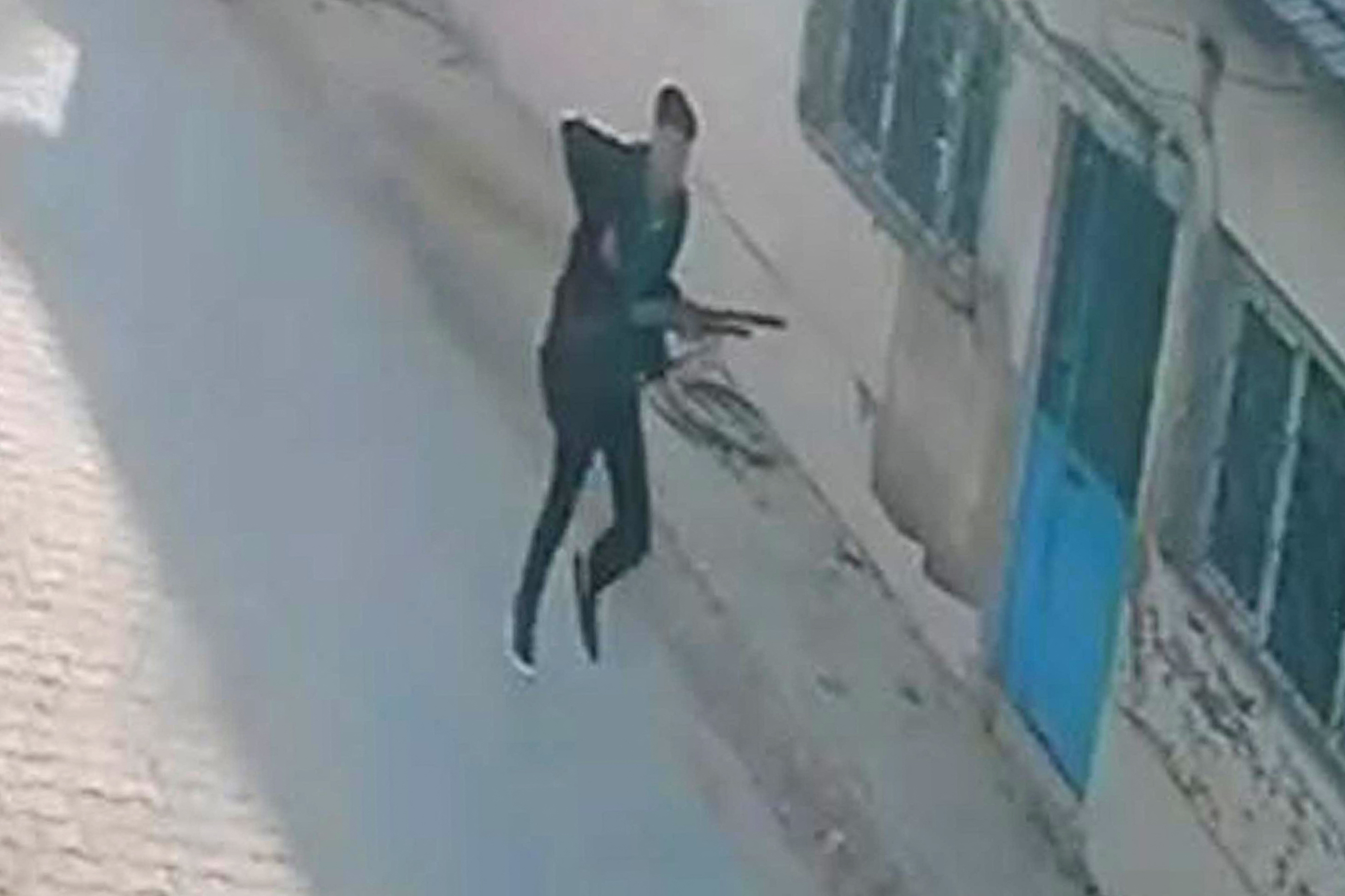 This handout photograph taken and released on September 22,2026 by Turkish news agency DHA (Demiroren News Agency) shows a CCTV image of a gunman running near a school in Turgutlu, an area west of the resort city of Izmir.