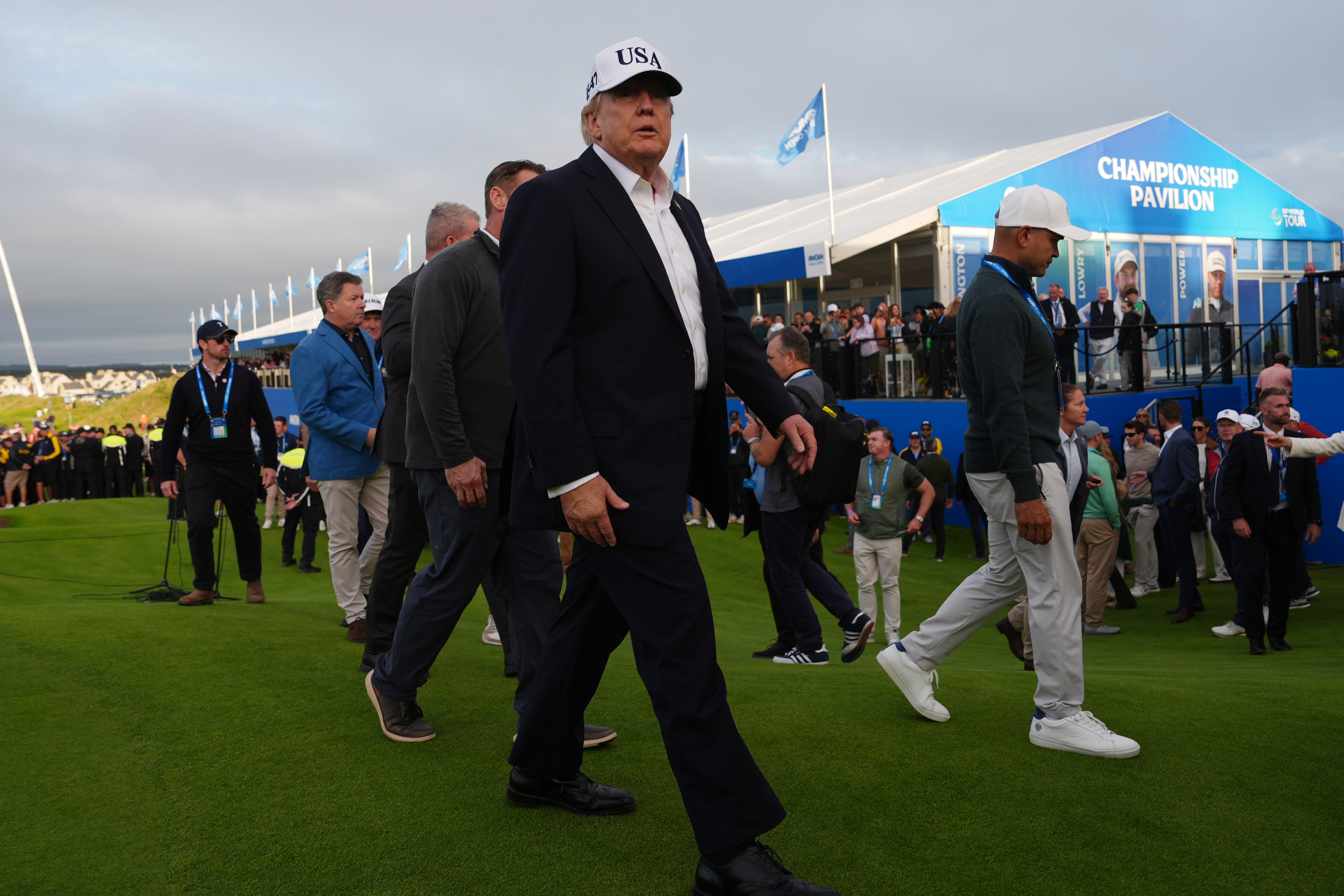 Donald Trump walks across a golf course