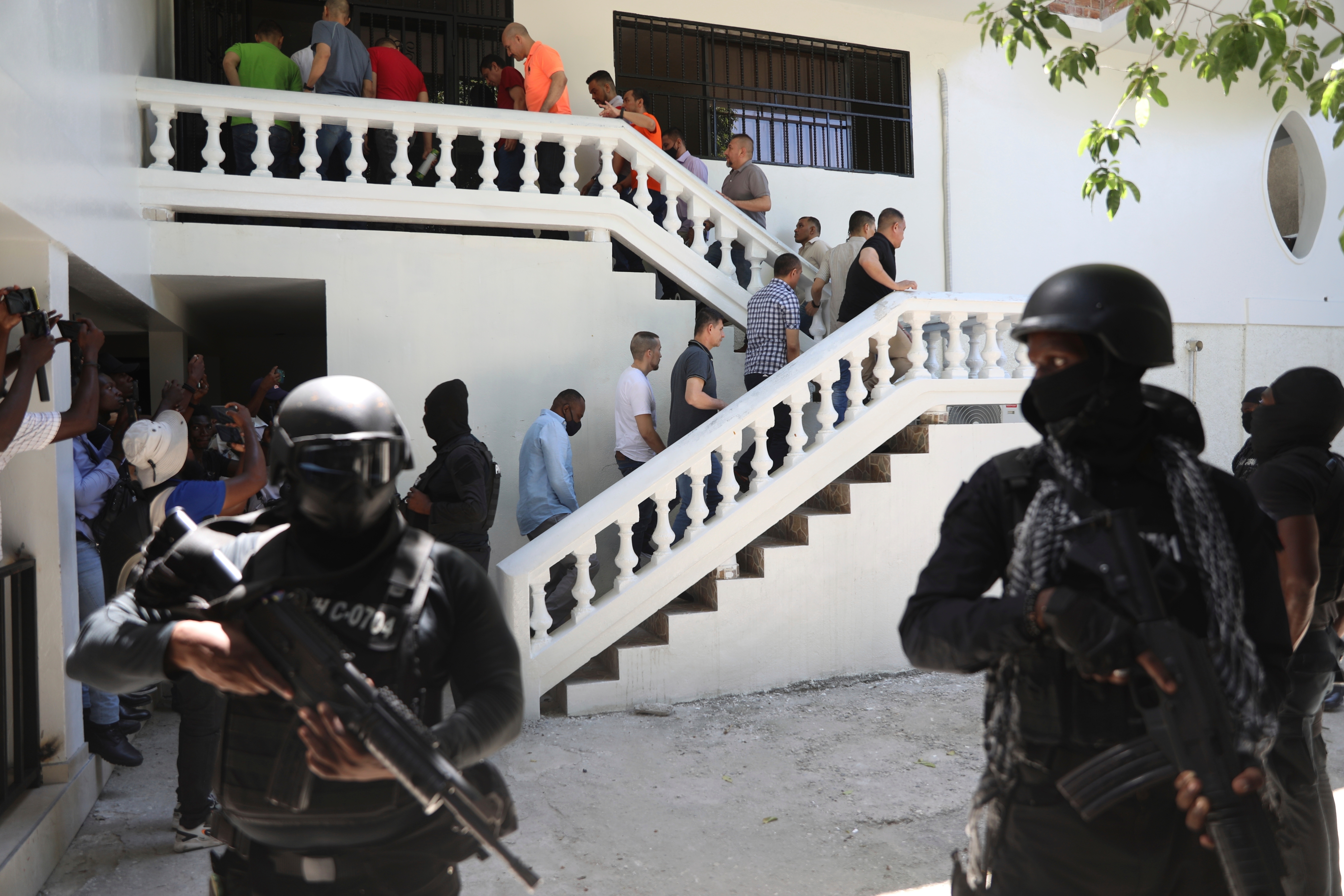 FILE - Colombians and Haitians who are accused of involvement in the 2021 assassination of Haitian President Jovenel Moise are escorted in handcuffs to their court hearing in Port-au-Prince, Haiti, May 26, 2025. (AP Photo/Odelyn Joseph, File)