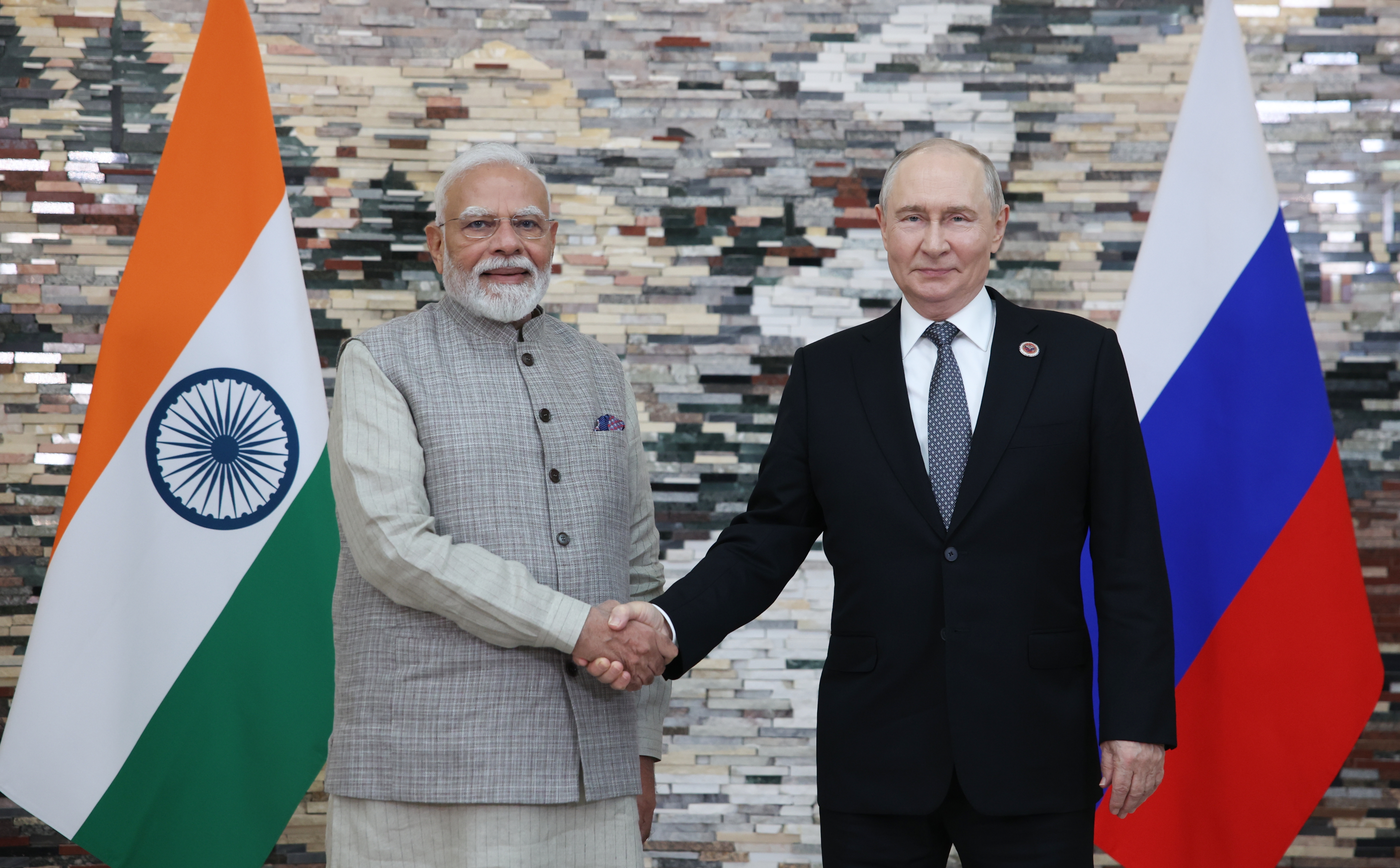 Indian Prime Minister Narendra Modi (L) and Russian President Vladimir Putin shake hands as they pose for photos before a meeting on the sidelines of the Shanghai Cooperation Organization (SCO) summit in Bishkek, Kyrgyzstan, on August 31, 2026.