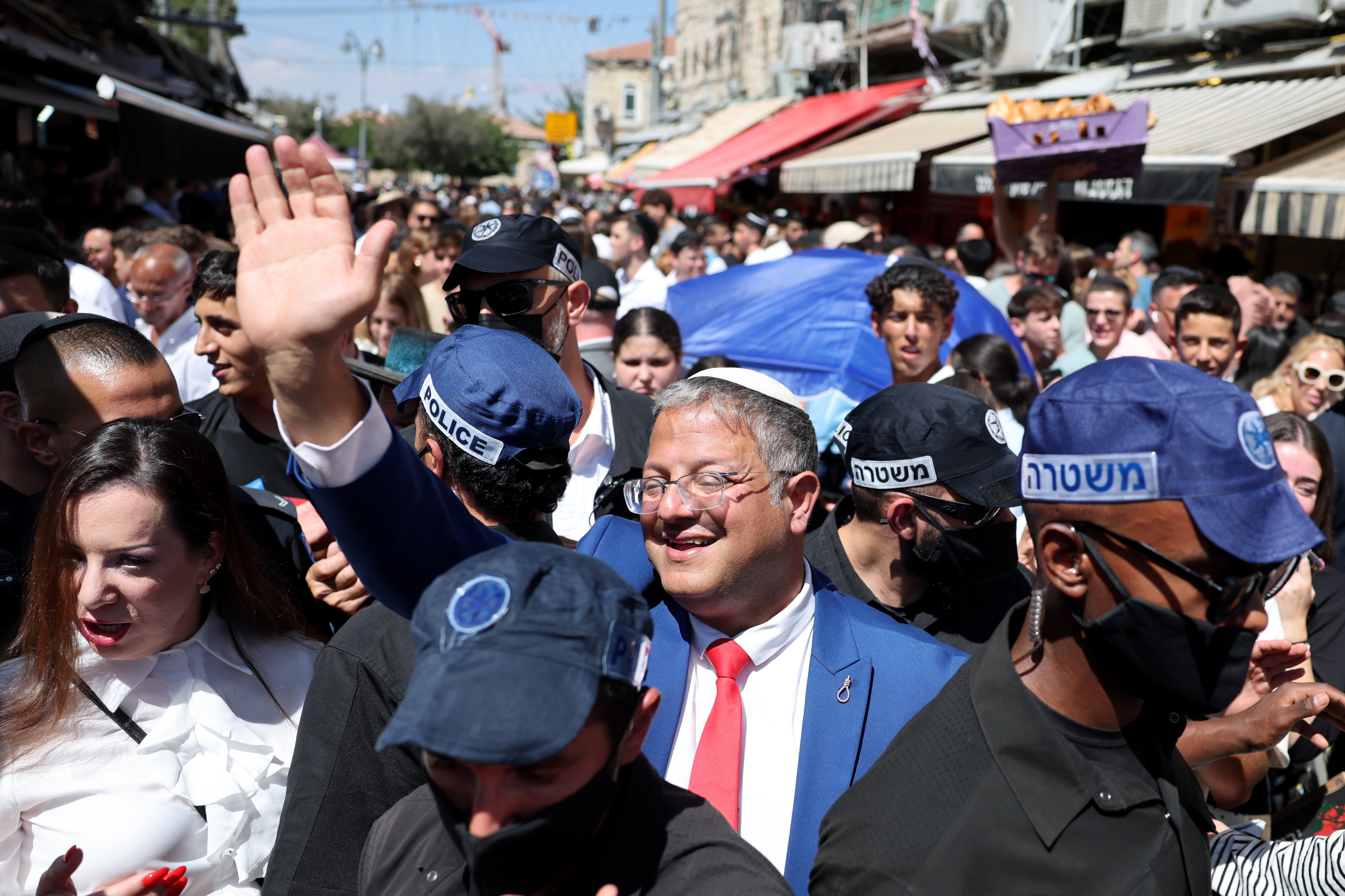 Israeli National Security Minister Itamar Ben-Gvir (C) waves as he visits the Mahaneh Yehudah Market in West Jerusalem, 04 September 2026