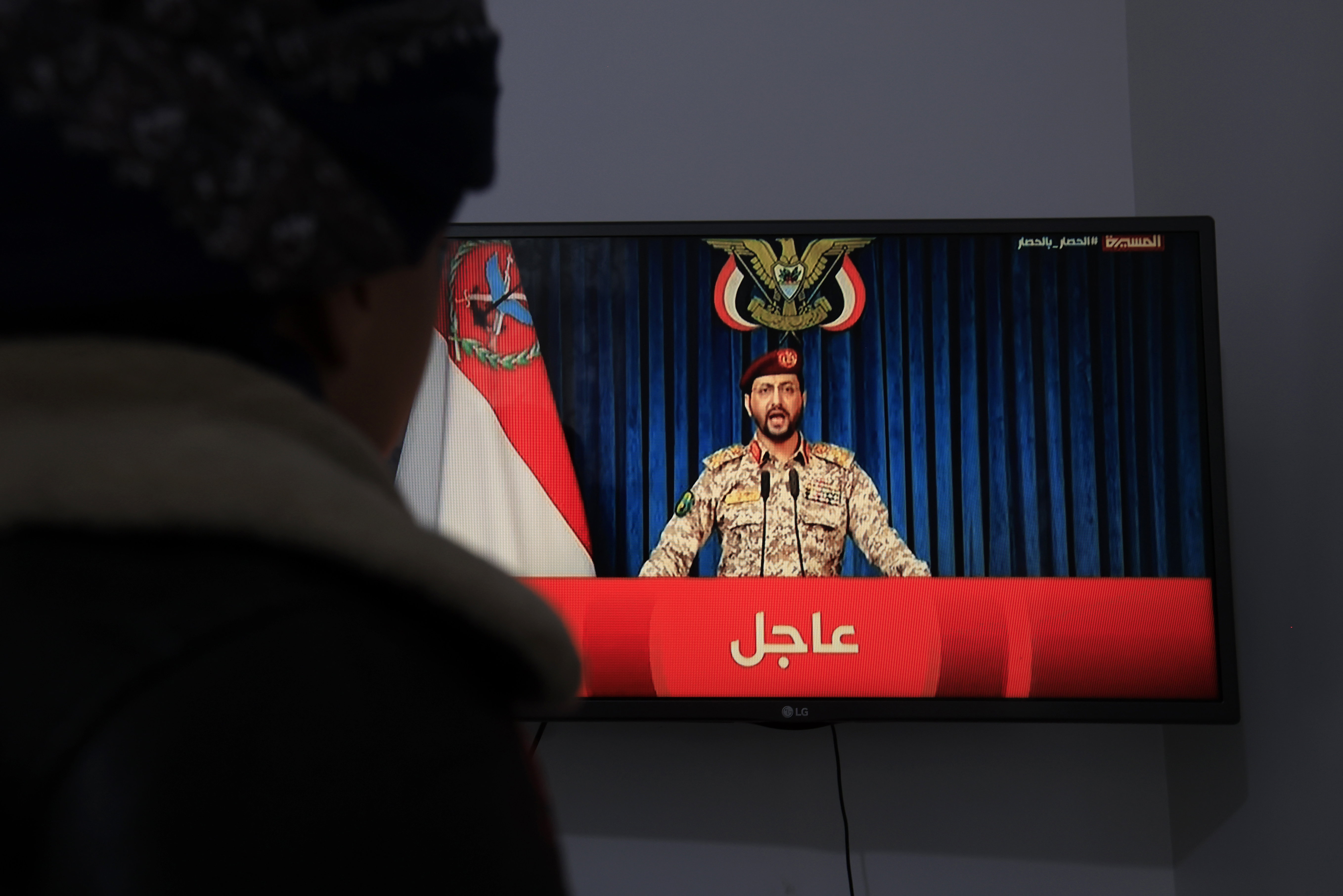 epa13231988 A person watches Houthi military spokesman Yahya Sarea delivering a televised statement, in Sana'a, Yemen, 11 September 2026. Yemen's Houthi group has warned Saudi vessels, which it says are still 'subject to a blockade', against passing through the Red Sea and the Bab Al-Mandab Strait, a day after Houthi forces expelled Saudi-backed Yemeni government forces from the country's western coast and captured several strategic sites on the strait, according to a statement by Houthi military spokesman Yahya Sarea. EPA/YAHYA ARHAB