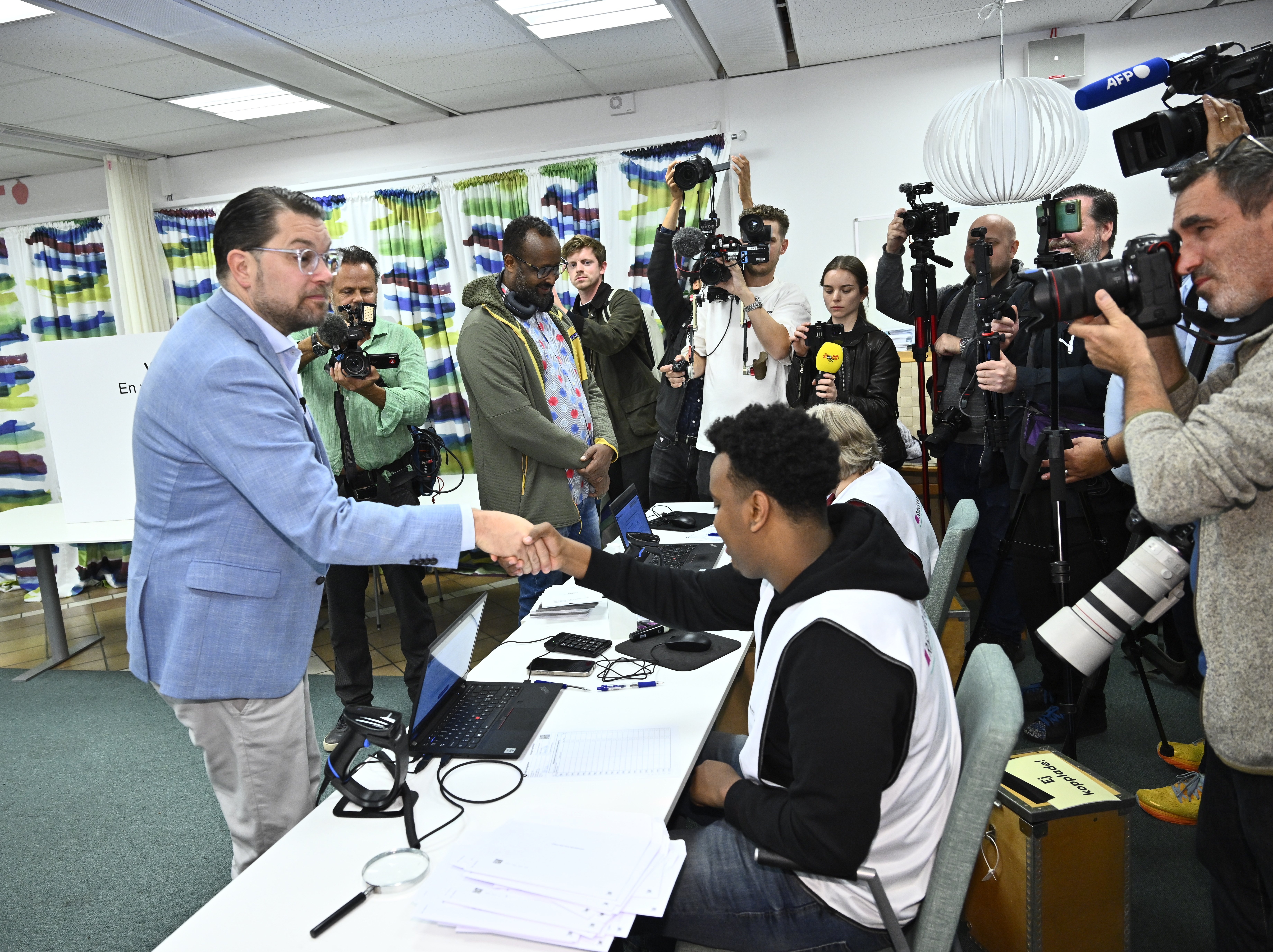 epa13233732 Sweden Democrats party leader Jimmie Akesson (L) votes in Rinkeby, a suburb of Stockholm, Sweden, 12 September 2026, the day before the general election. Sweden's general election will take place on 13 September 2026, with voters electing members of the Riksdag as well as representatives in regional and municipal elections. EPA/CLAUDIO BRESCIANI SWEDEN OUT