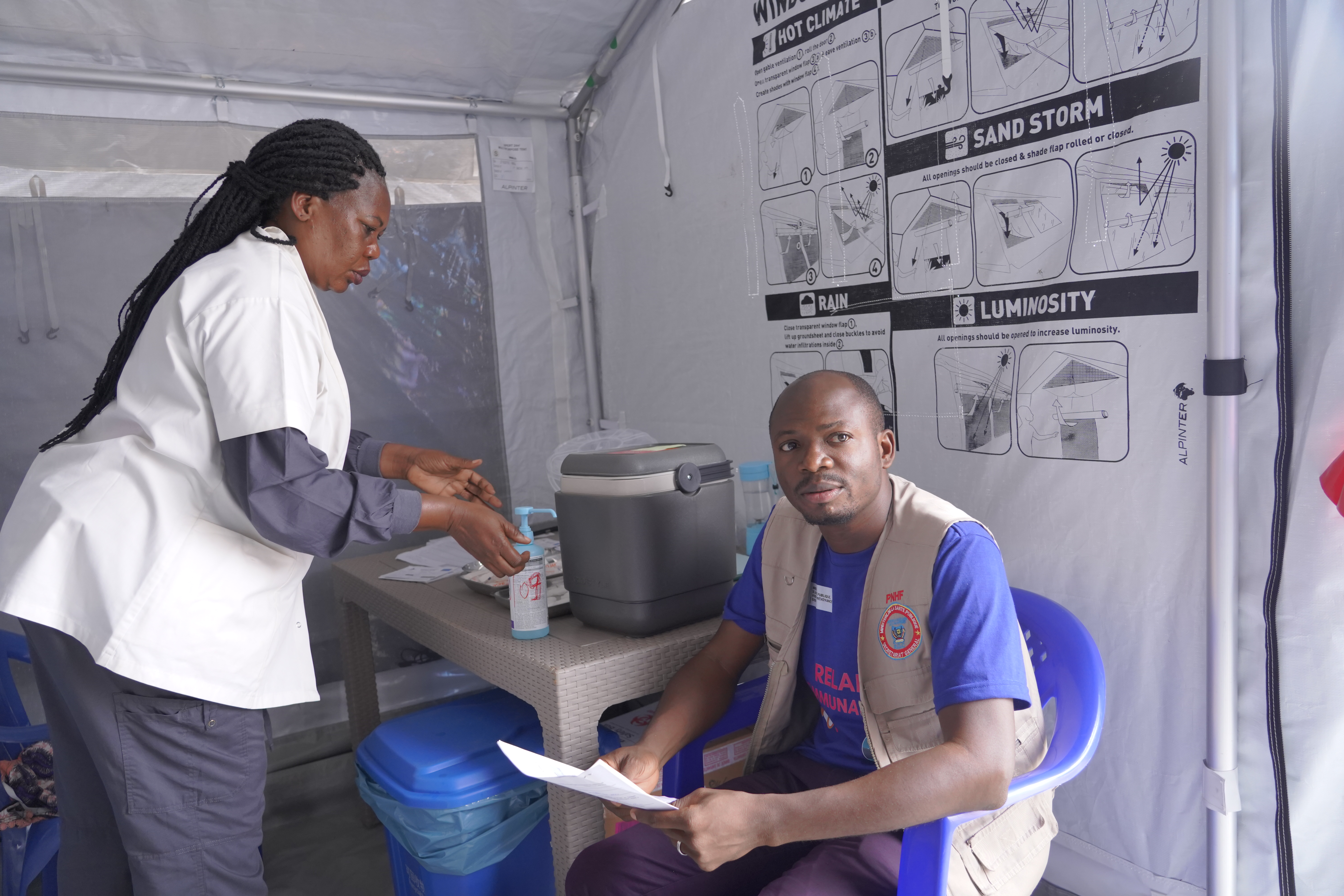 A healthcare worker waits to receive the Ervebo vaccine at a treatment centre in Bunia