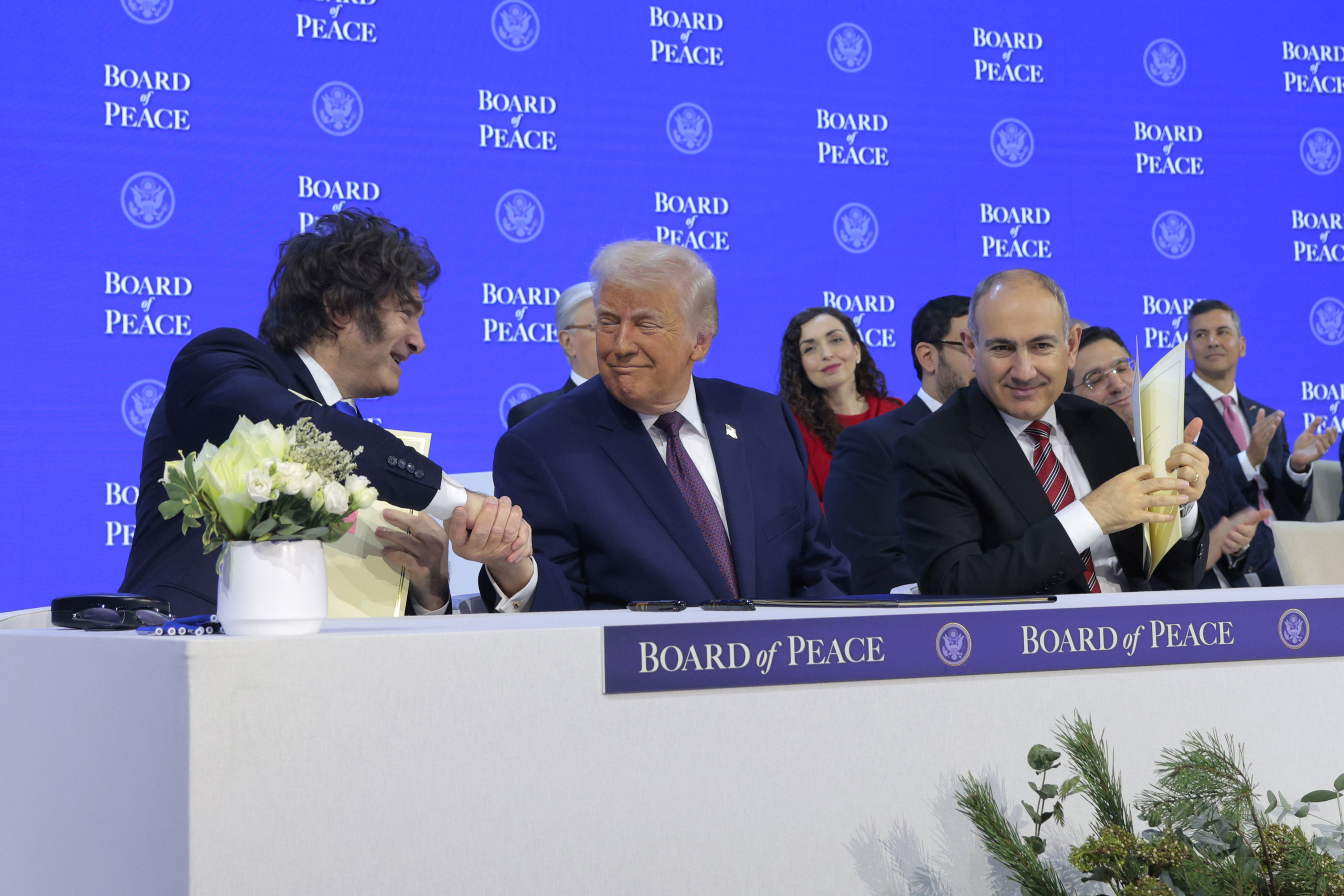 DAVOS, SWITZERLAND - JANUARY 22: U.S. President Donald Trump shakes hands with President of Argentina Javier Milei during a signing ceremony for the “Board of Peace” at the World Economic Forum (WEF) on January 22, 2026 in Davos, Switzerland. The US-backed “Board of Peace” is intended to administer the fragile ceasefire in the Gaza Strip after the war between Israel and Hamas. The final makeup of the board has not been confirmed. (Photo by Chip Somodevilla/Getty Images)