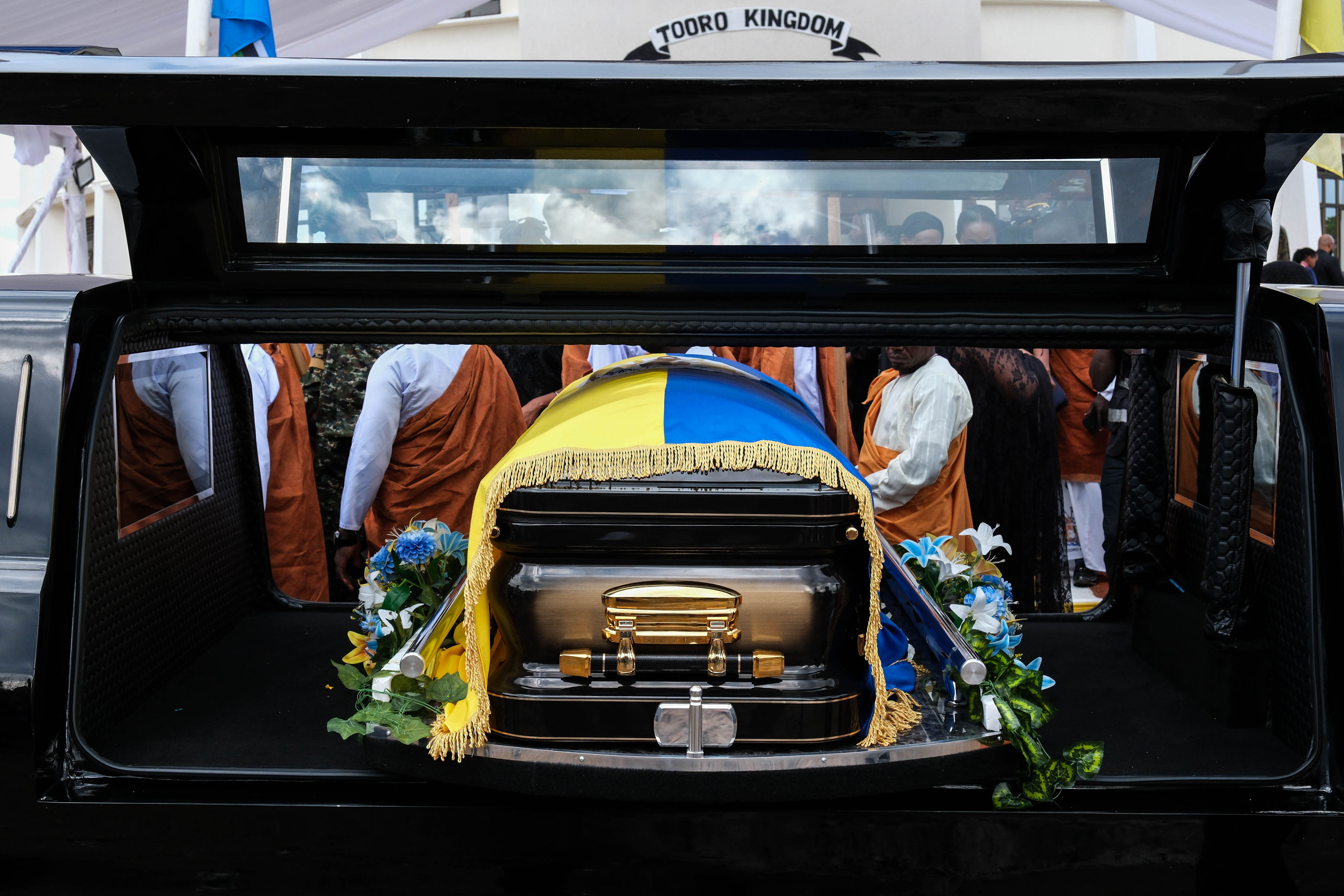 FORT PORTAL, UGANDA - SEPTEMBER 12: A casket containing the body of the Late Oyo Nyimba Kabamba Iguru Rukidi IV is loaded on a cortege after leaving the Karuziika Royal Palace ahead of the burial at the Karambi Royal Tombs on September 12, 2026 in Fort Portal, Uganda. An official burial is taking place for Oyo Nyimba Kabamba Iguru Rukidi IV, a traditional Ugandan ruler of the Tooro kingdom, who died aged 34 on August 27, 2026, while being treated for a critical illness in the United States. In the wake of the king's death, a dispute has broken out between the monarch's family and the succession committee over who should succeed him. (Photo by Hajarah Nalwadda/Getty Images)