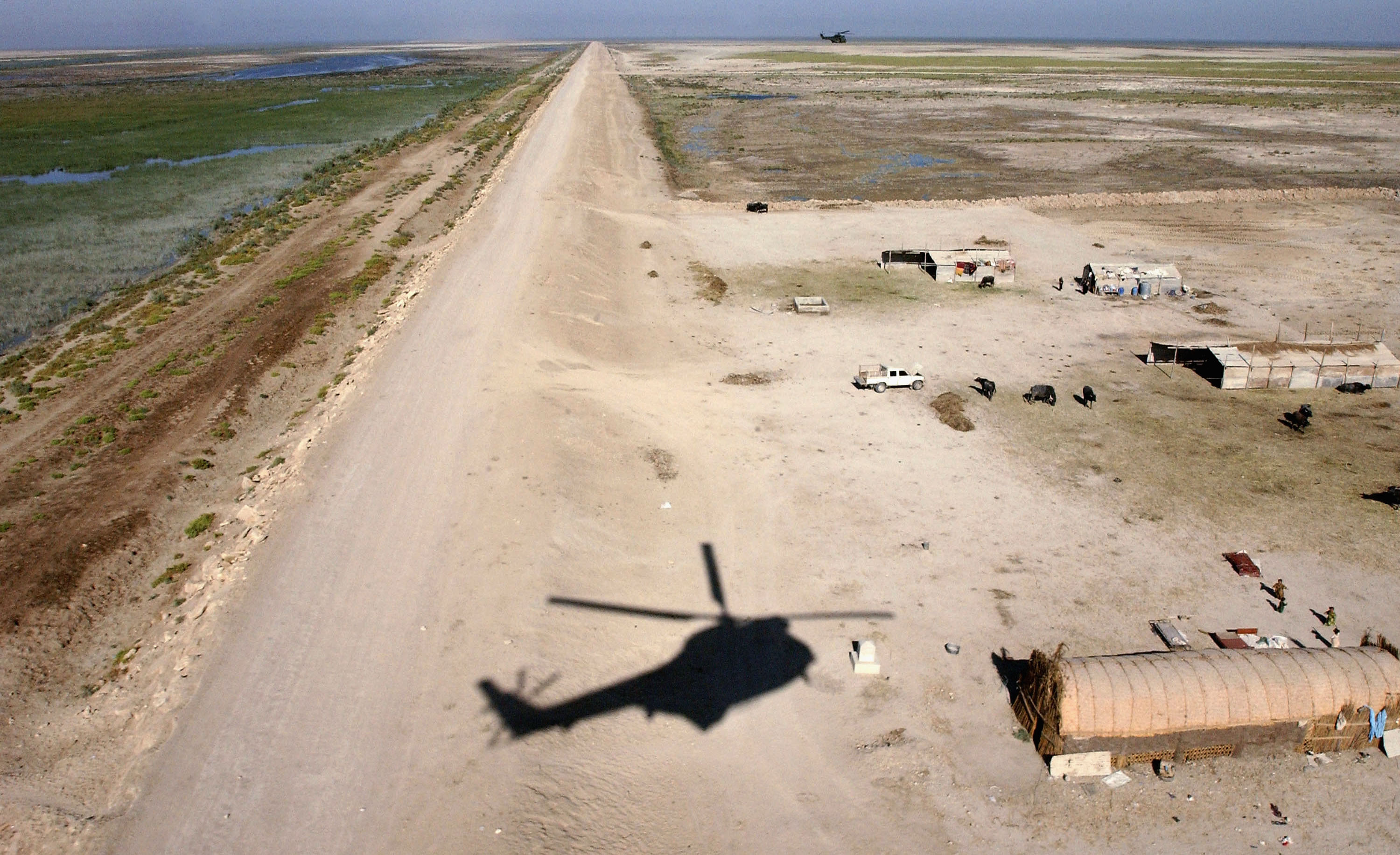 MAYSAN PROVINCE, IRAQ - OCTOBER 9: A Royal Air Force Puma helicopter flies a mission October 9, 2004 over the Maysan Province in southern Iraq. The Royal Air Force and the U.S. Air Force are providing logistic support, training facilities and instructors to about 20 Iraqi Air Force pilots and air crew. (Photo by Marco Di Lauro/Getty Images)