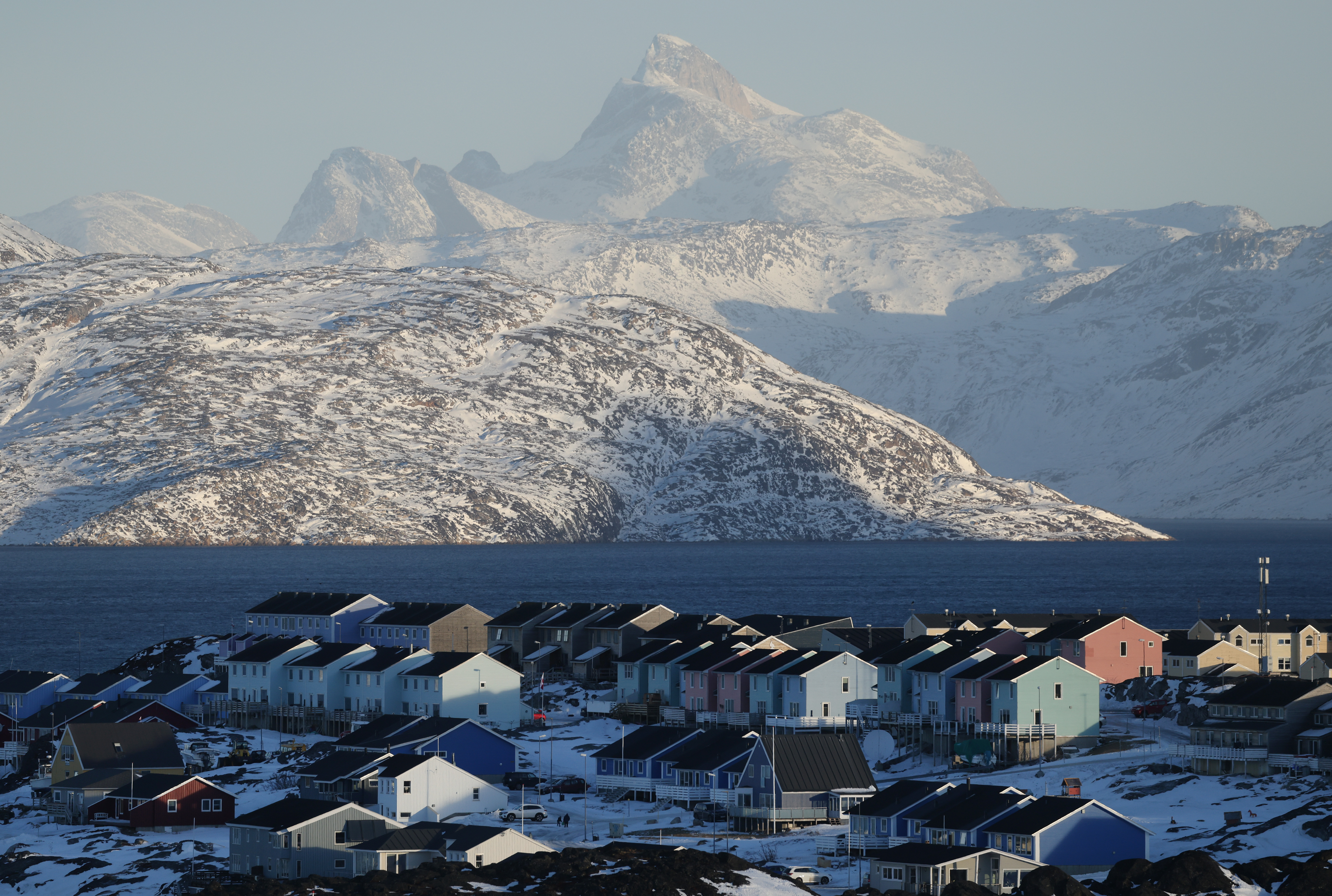 Residential apartment buildings stand among snow.