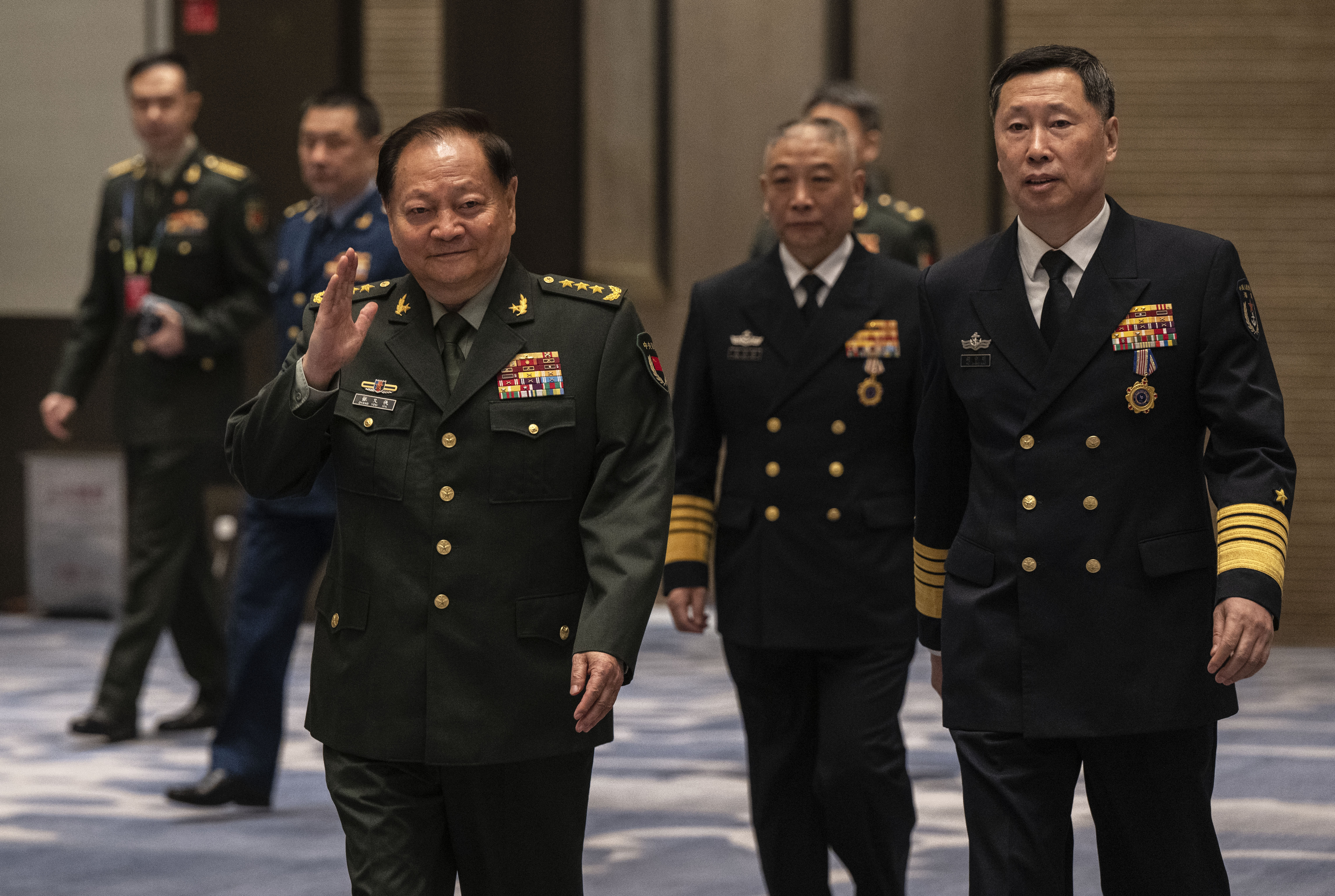 Vice Chairman of the Central Military Commission Gen. Zhang Youxia waves as he arrives for a group photo before the opening of the Western Pacific Naval Symposium in Qingdao, China. [April 22, 2024: Kevin Frayer/Getty Images]