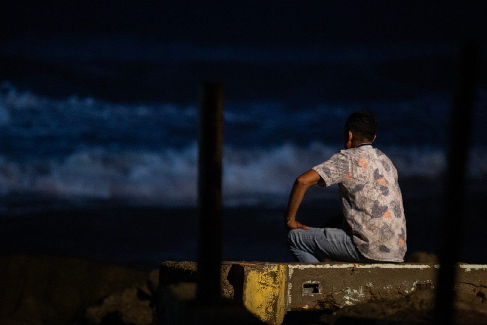 A man looks out to the sea at Playa Jardin in Lazaro Cardenas, Michoacan, Mexico on September 22, 2026. [ENRIQUE CASTRO / AFP]