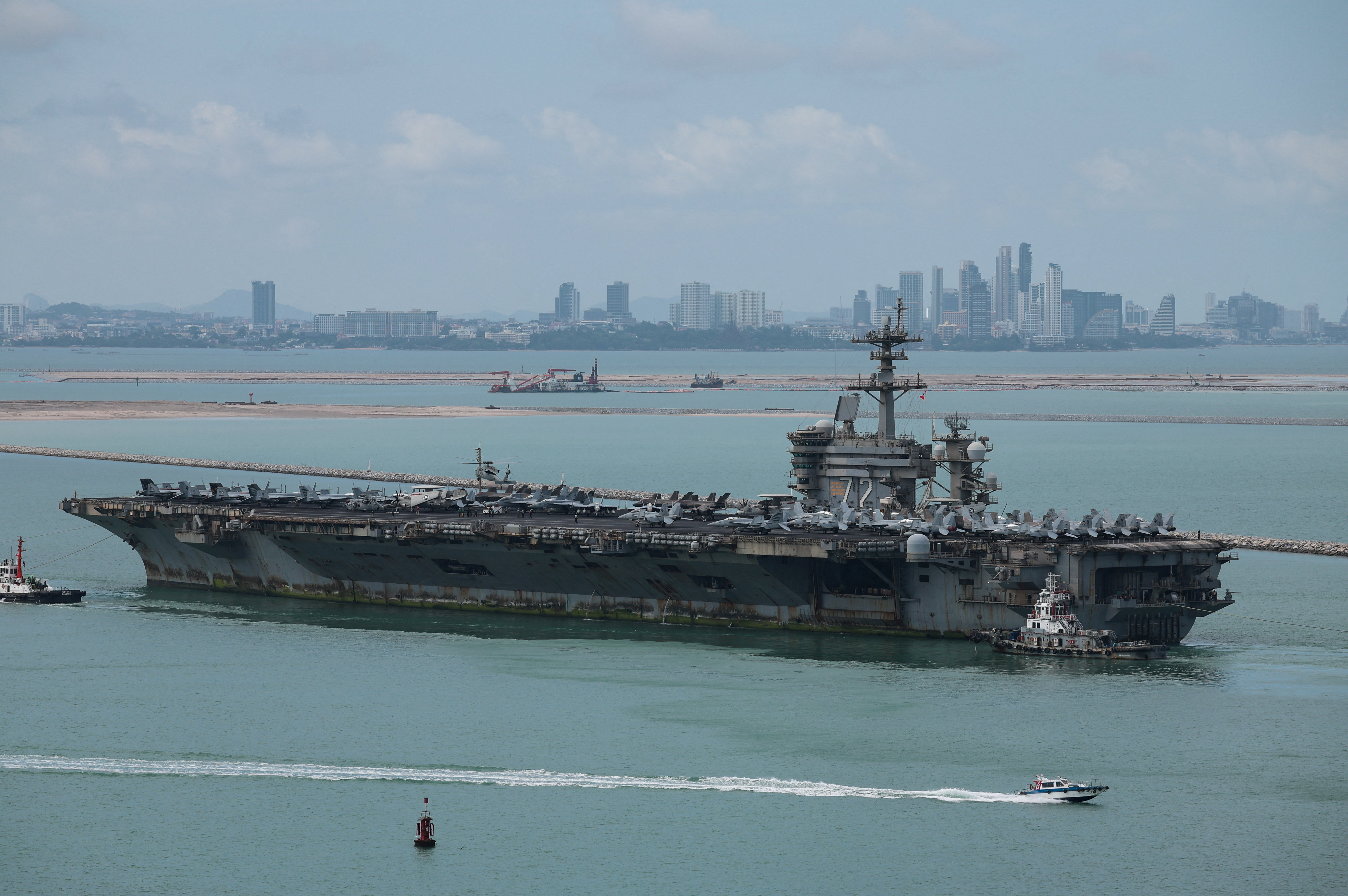 The U.S. Navy Nimitz-class aircraft carrier USS Abraham Lincoln sails toward Laem Chabang Port before docking for a rest stop following a long deployment in the Middle East, with the Pattaya skyline in backdrop, in Chonburi province, Thailand, September 2, 2026. REUTERS/Chalinee Thirasupa