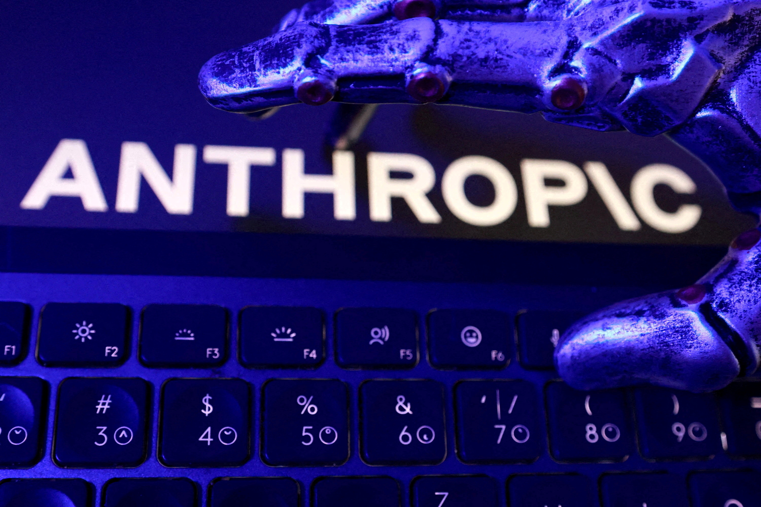 Anthropic logo, a keyboard, and a robotic hand.