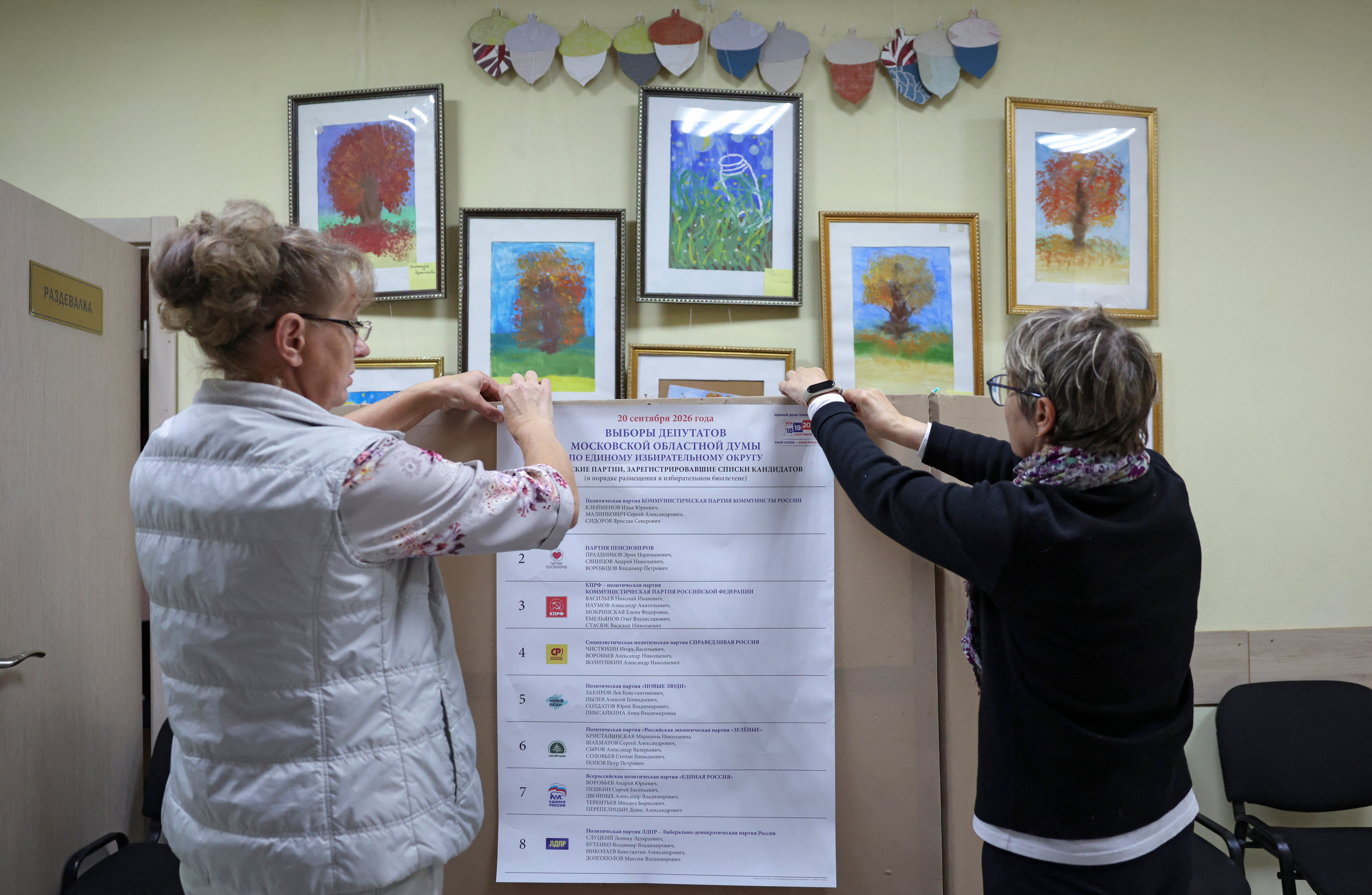 Election officials hang a list of political parties at a polling station ahead of the parliamentary elections in Podolsk, Moscow region, Russia, September 17, 2026. REUTERS/Ramil Sitdikov