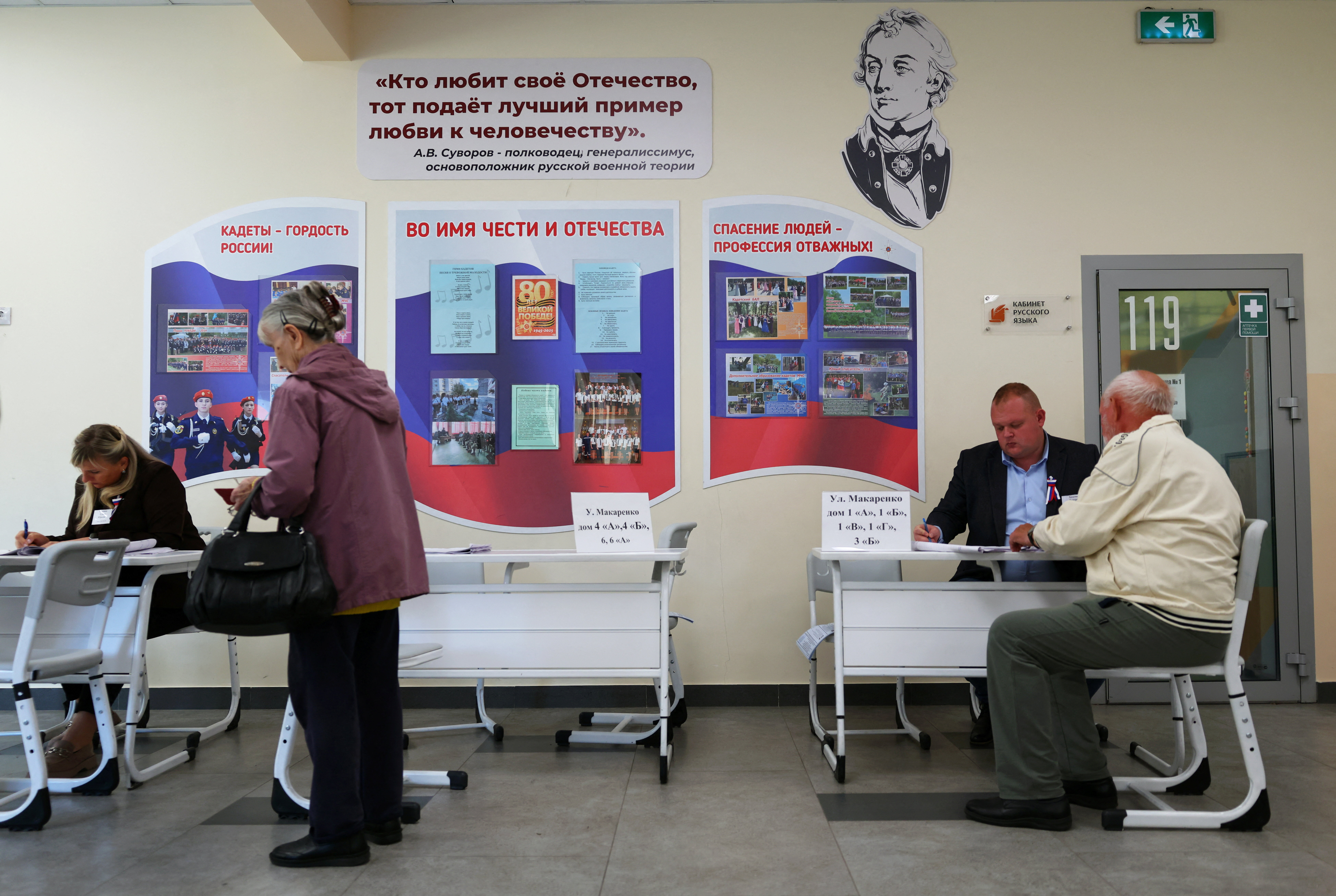 Voters receive their ballots at a polling station on the first day of Russia's parliamentary election in Belgorod, Russia, September 18, 2026. REUTERS/Stringer